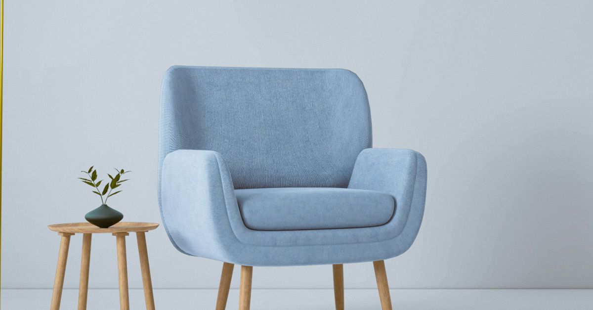 a blue chair and a yellow lamp in a white room