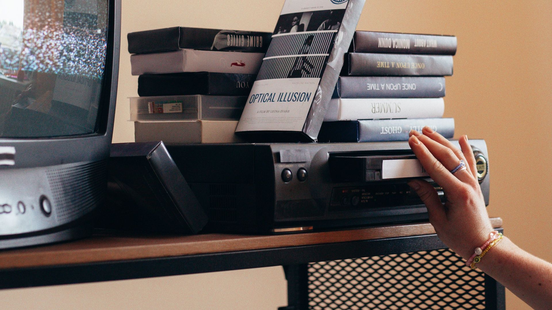 Vintage scene with a VHS player, tapes, and an old CRT TV creating a nostalgic vibe.