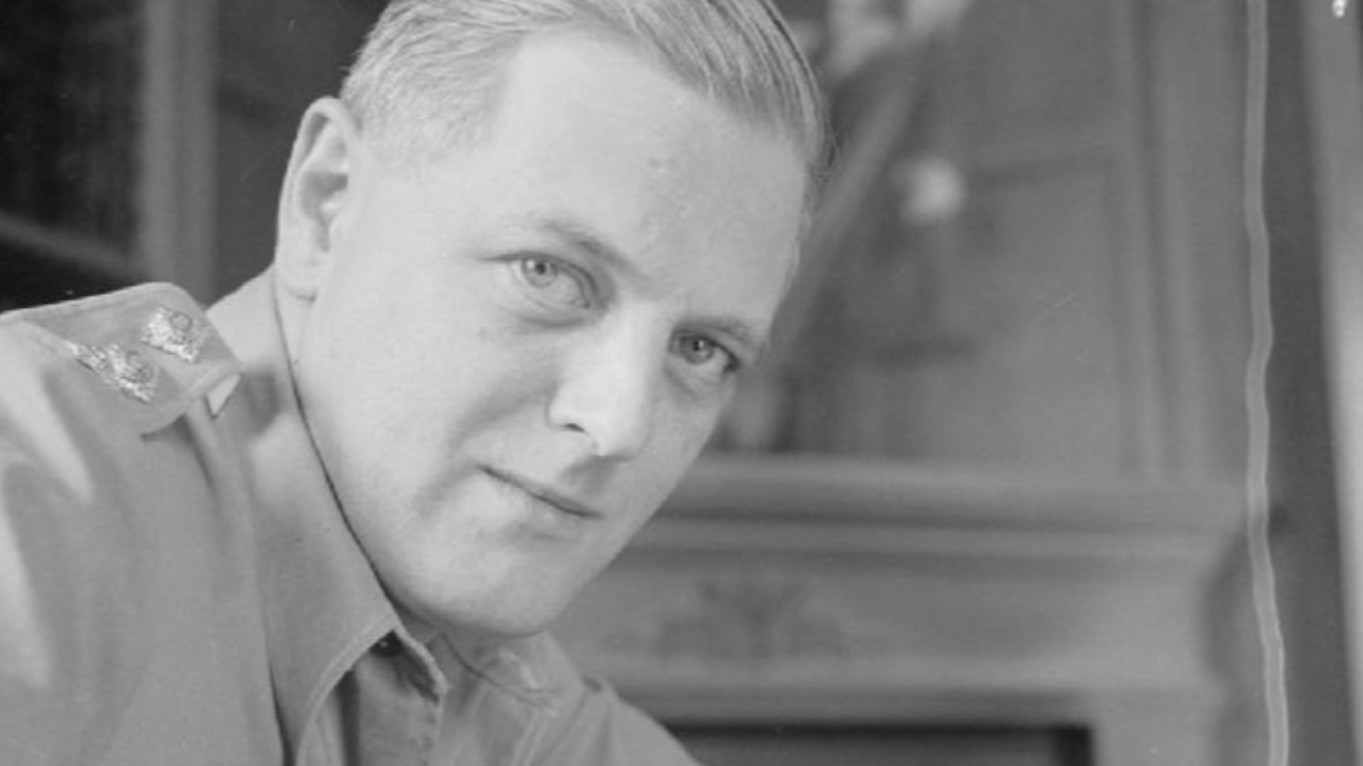 Cecil Beaton Photographs- Political and Military Personalities
Military Personalities: Head and shoulders portrait of Captain Randolph Churchill, as an Army Intelligence Officer in Cairo at his desk.