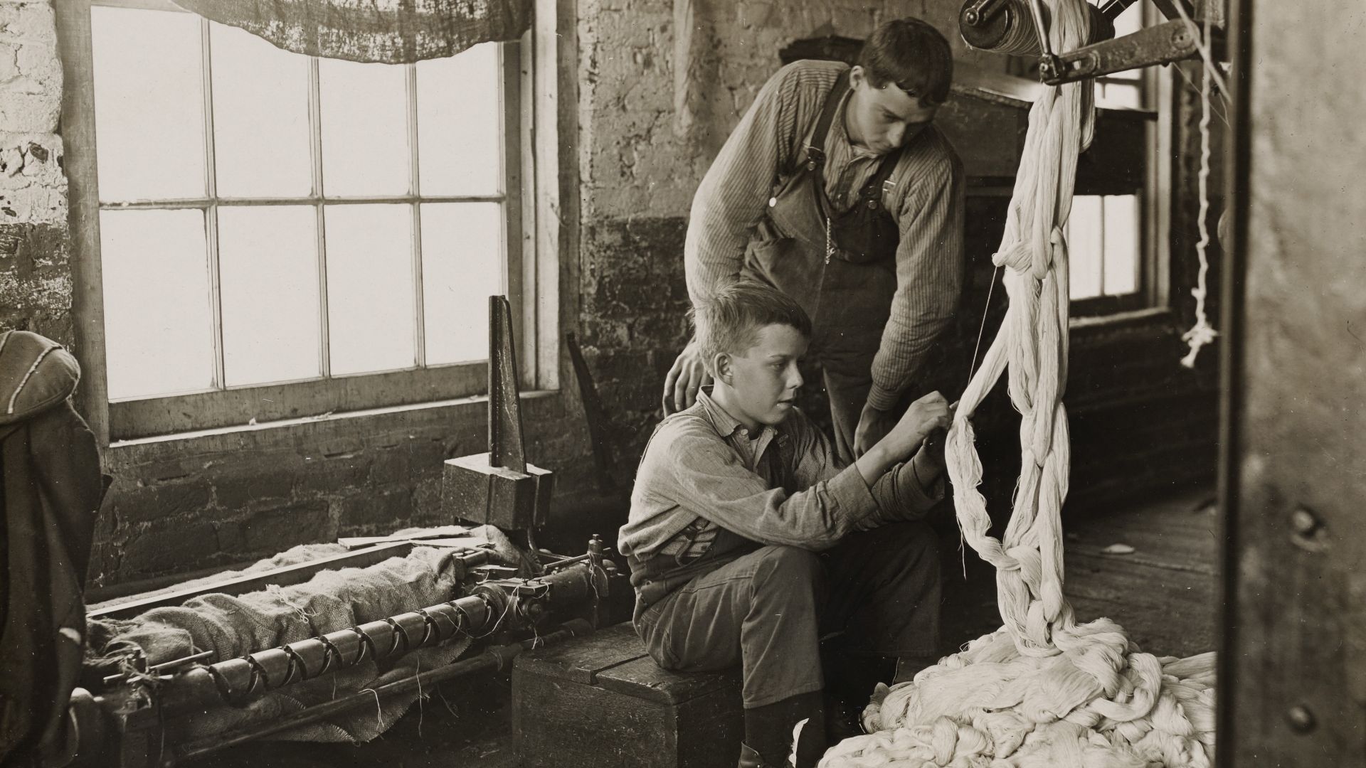 Photographer: Hine, Lewis Wickes
Boy at warping machine. 
Been there 2 years. Clyde Cotton Mill. 
Location: Newton, North Carolina, USA 1908.

NMFF.003475