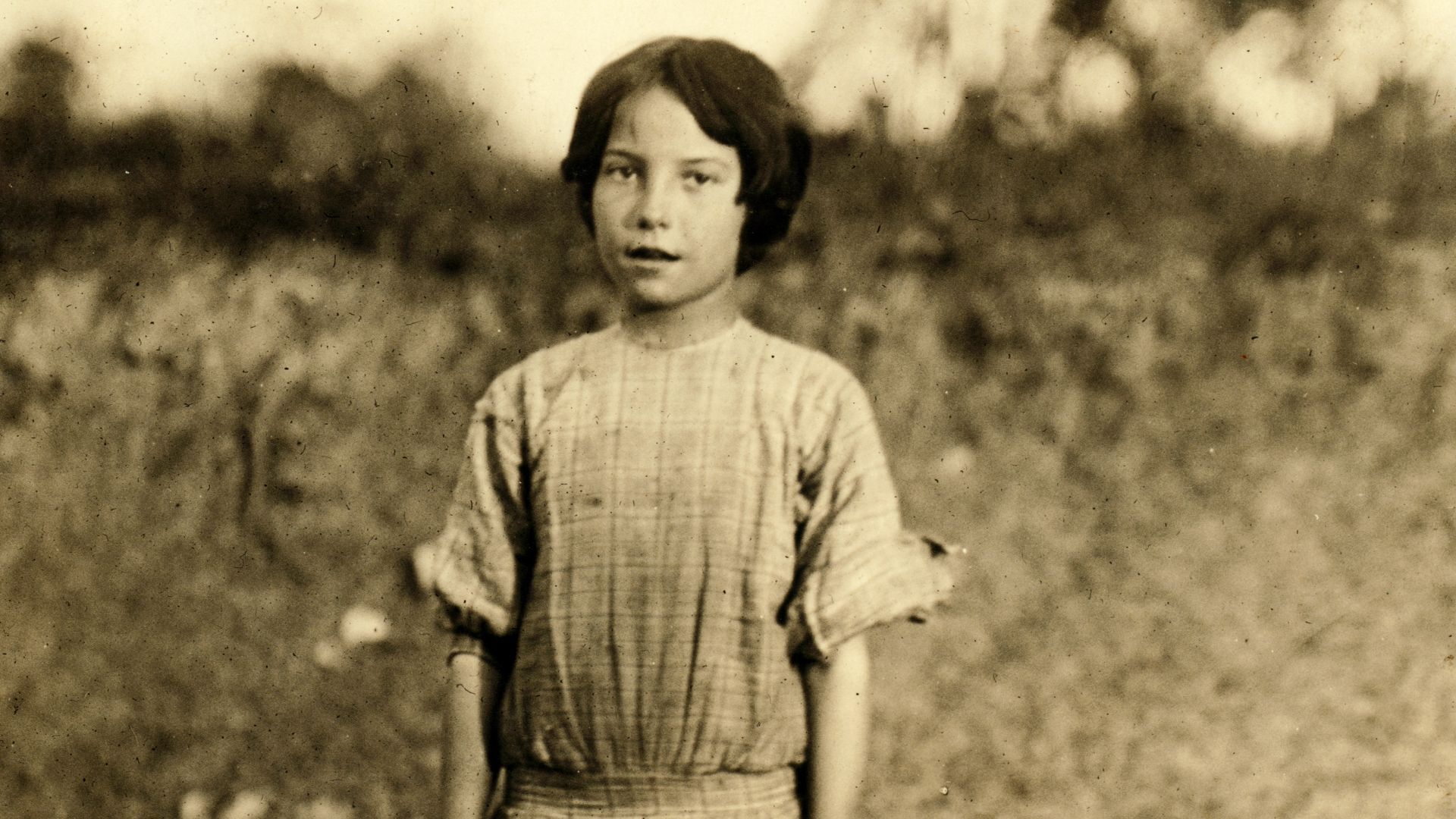 Ruth Rous. She said she was 11 yrs old, but others there said she was not 10. She has a regular job, and several sisters are working. Deep River Cotton Mills. Location: Randleman, North Carolina. Photograph by Lewis Wickes Hine, May 1913.