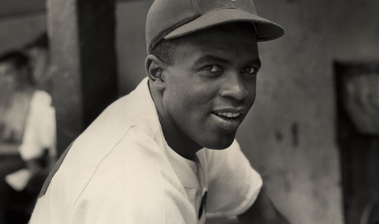  A portrait of the Brooklyn Dodgers' infielder Jackie Robinson in uniform.