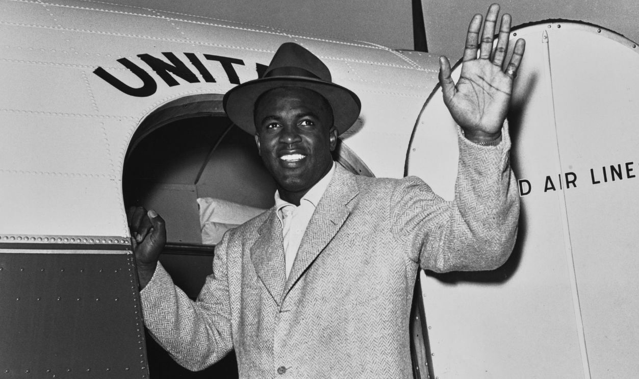 American baseball player Jackie Robinson boarding a plane in Los Angeles, March 6th 1950. He is flying to Vero Beach in Florida to join the Brooklyn Dodgers at spring training. Robinson was delayed in Hollywood where he had been working on a film about his life