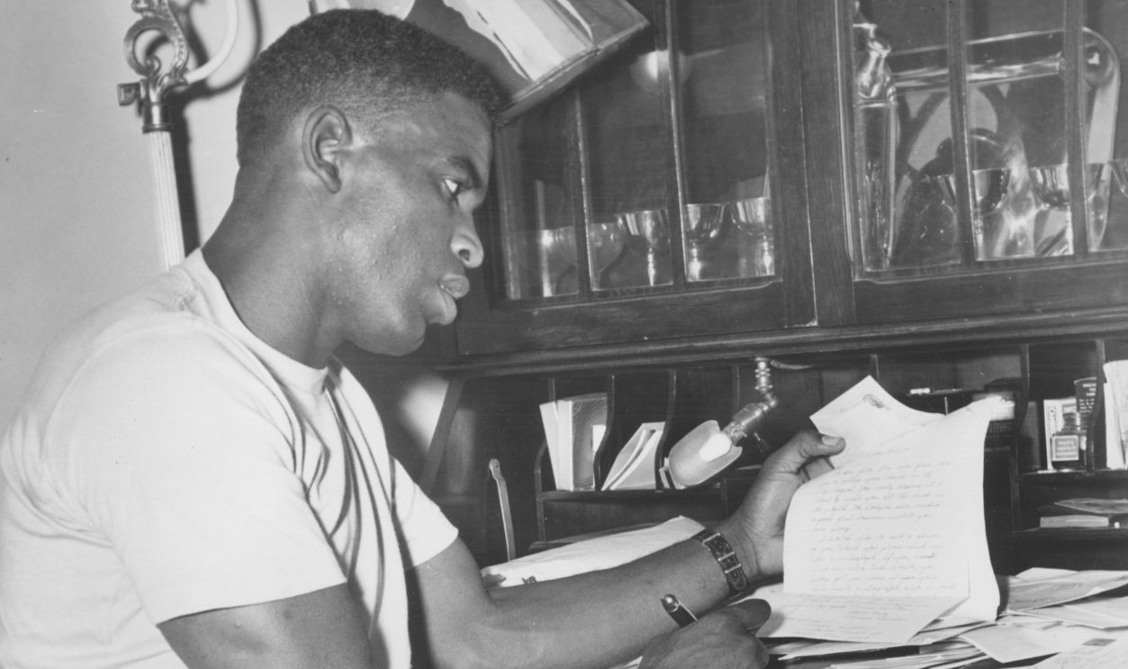 American baseball player Jackie Robinson (1919 - 1972) of the Brooklyn Dodgers at his writing desk, New York, New York, October 22, 1947.