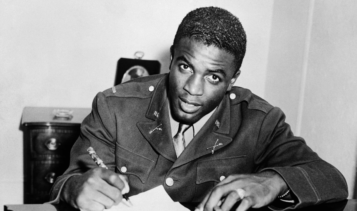 Jackie Robinson, in military uniform, becomes the first African American to sign with a white professional baseball team. He signs a contract with the minor league club in Montreal, a farm team for the Brooklyn Dodgers.