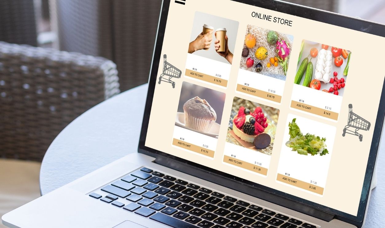 Close up woman sitting and ordering food online on laptop computer in add to cart function webpage