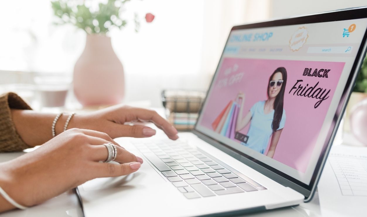 Hands of young woman over laptop keypad going to surf through online goods and order something