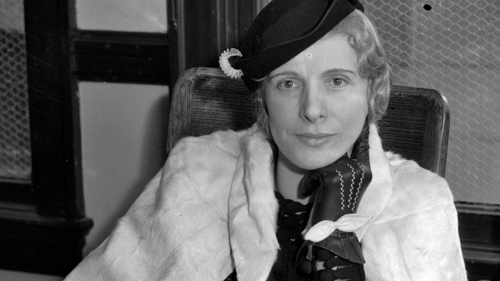 Aimee Semple McPherson seated in a law office