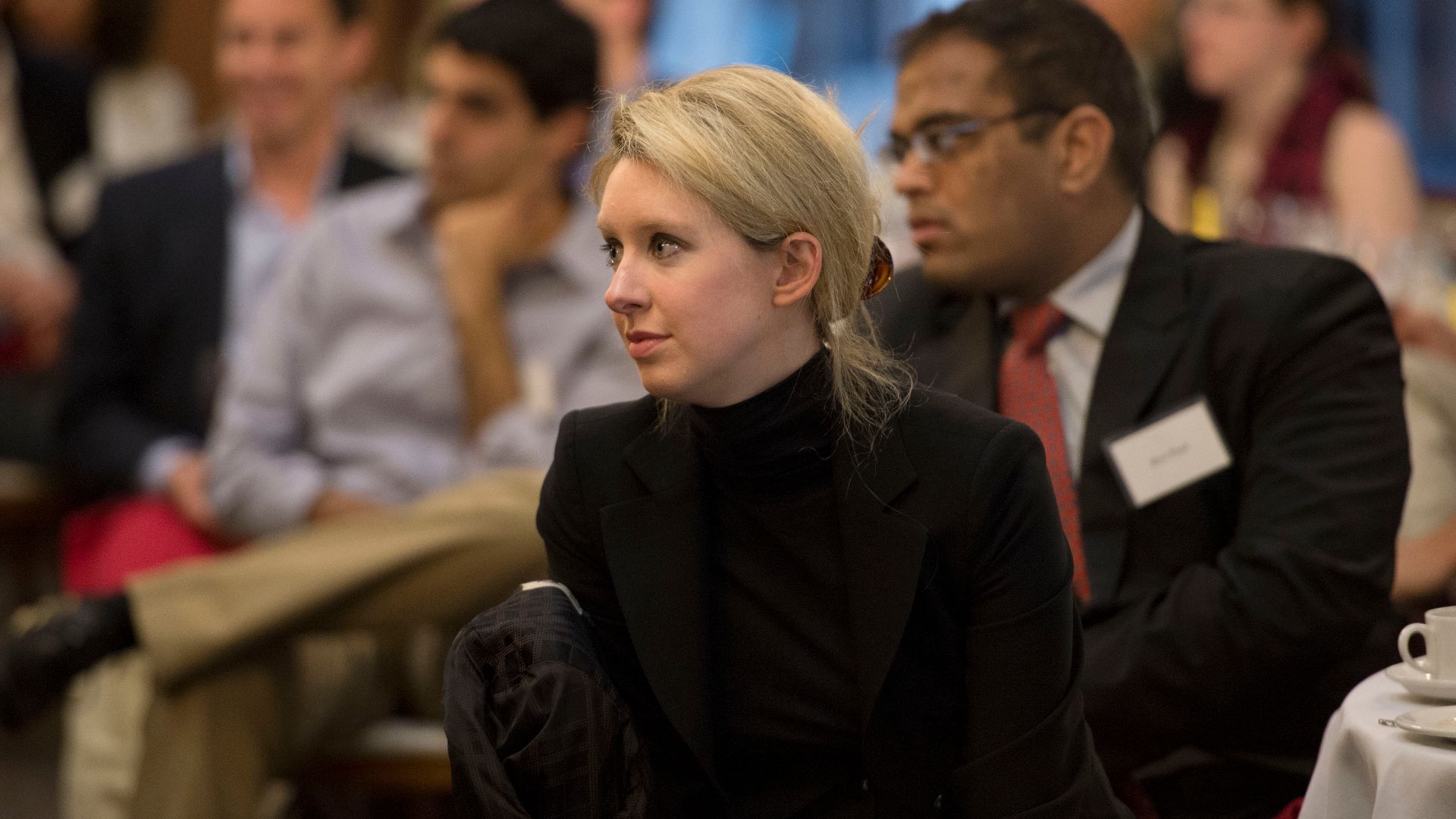 Elizabeth Holmes, the chief executive officer and founder of Theranos, a health care technology company, listens as Deputy Secretary of Defense Ash Carter speaks at Stanford University in Palo Alto, Calif., April 17, 2013. (DoD photo by Glenn Fawcett/Rele