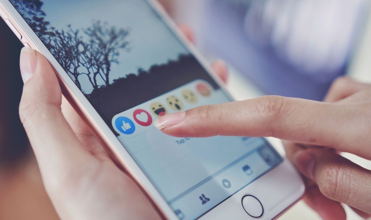 Bangkok, Thailand - January 7, 2018 : hand is pressing the Facebook screen on apple iphone6 ,Social media are using for information sharing and networking.