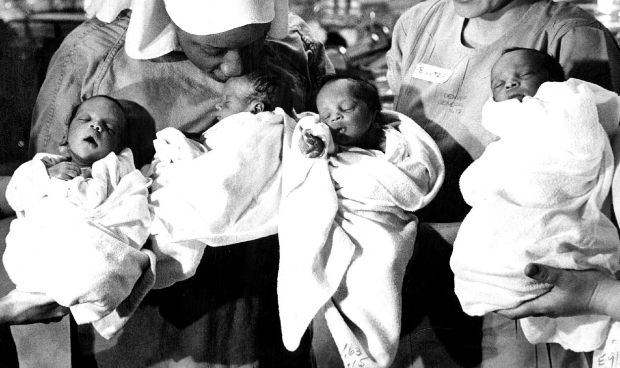 ONE HOME, THREE TO GO Mrs. Wilber Tarver, left, and nurse Barbara Lutz hold the Tarver quadruplets, born Dec. 7 at Denver General Hospital, just before Mrs. Tarver took one of the four home. The last-born and the biggest of the four was allowed to go home with Mrs. Tarver Wednesday while the other three must stay in the hospital until they gain more weight. Mrs. Tarver named the girl Neeomi but has not decided on names for her three sons, still known as A, B and D, in order of their birth. She took baby D home but baby B, the smallest, may remain in hospital for two or three weeks.