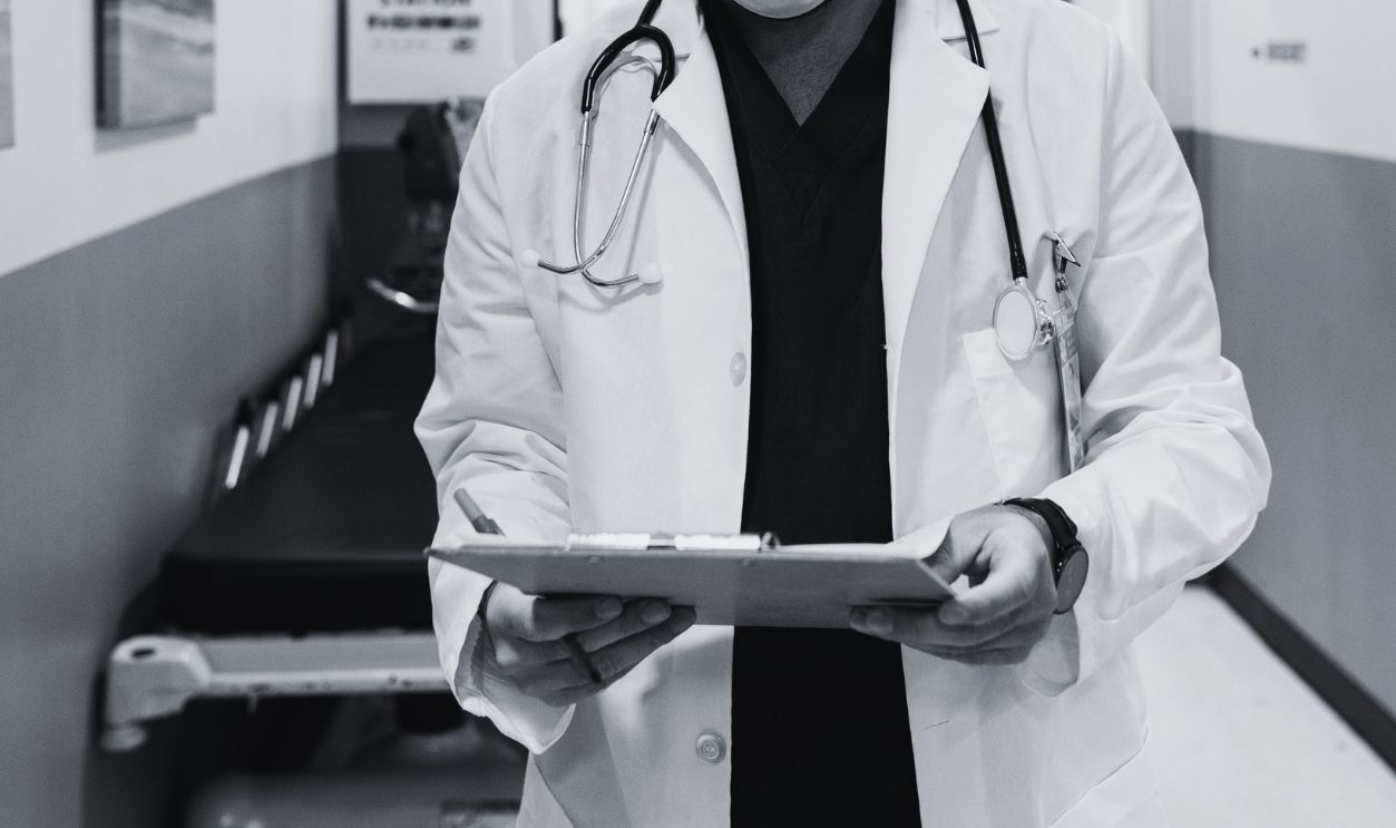 A healthcare professional reviewing medical charts in a hospital corridor, emphasizing safety