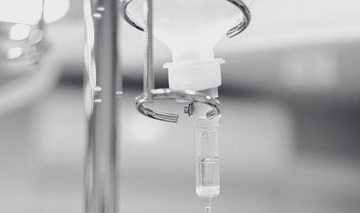 Close-up view of an IV drip chamber and stand in a clinical hospital