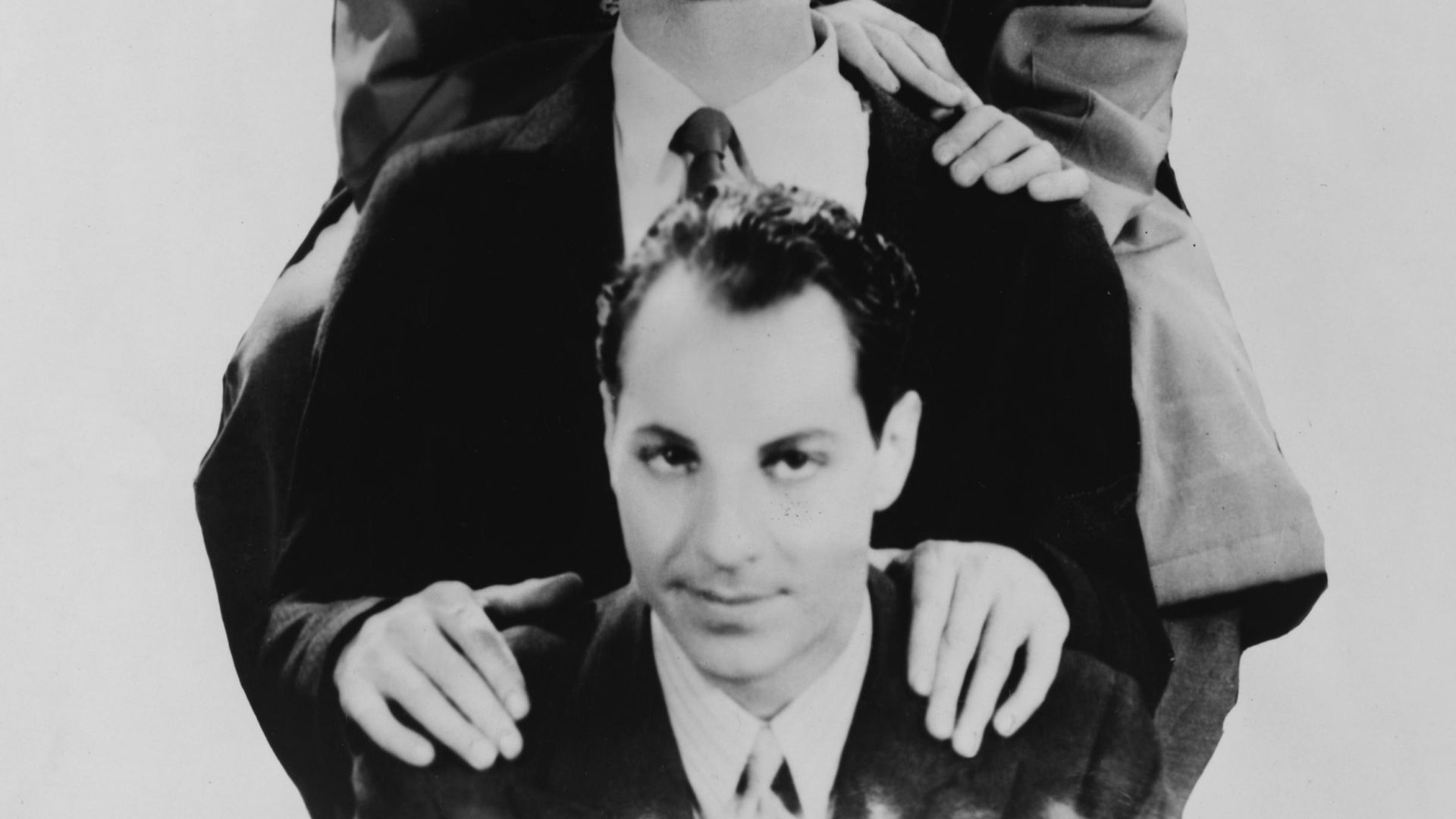 The Marx Brothers, head-and-shoulders portrait, facing front. Top to bottom: Chico, Harpo, Groucho and Zeppo.