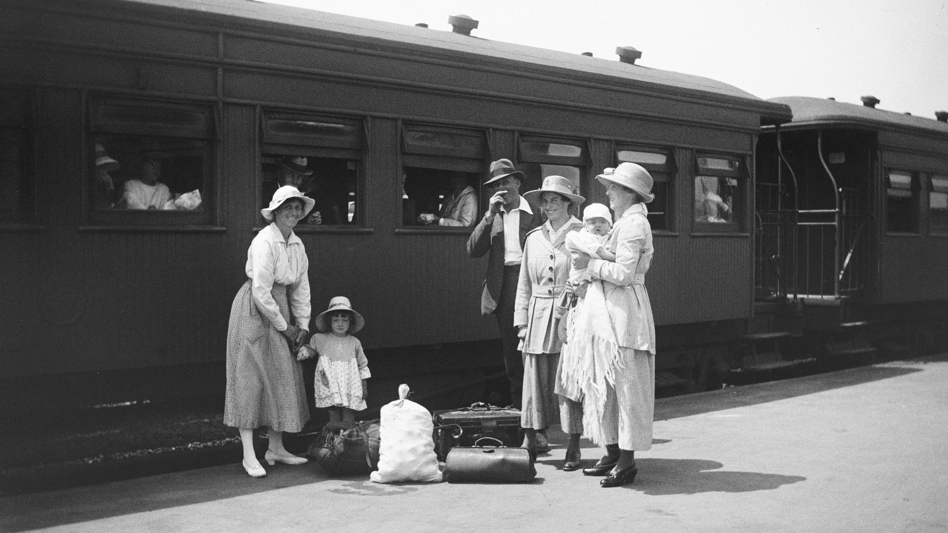 Family with luggage by a train