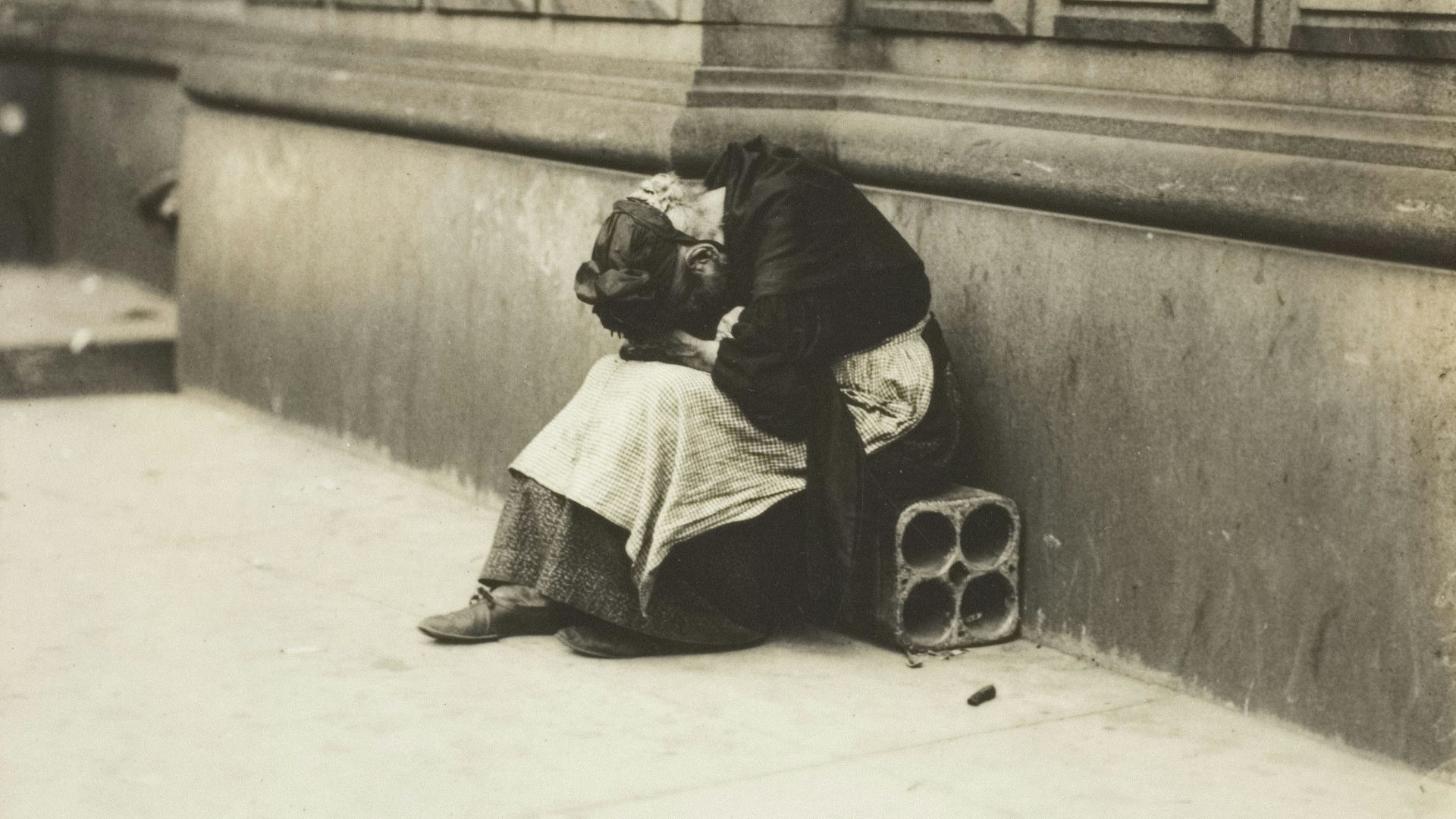 A couple embracing on a sidewalk
