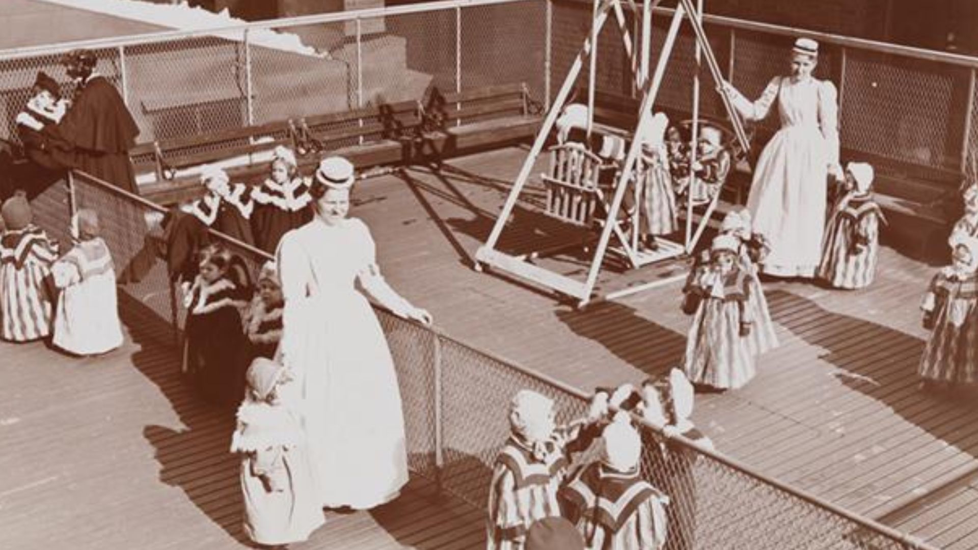 Children and nurses on the roof playground of the New York Foundling Hospital at 3rd Avenue between 68th and 69th Street. Swings are visible. Photo by Byron Company, circa 1899.