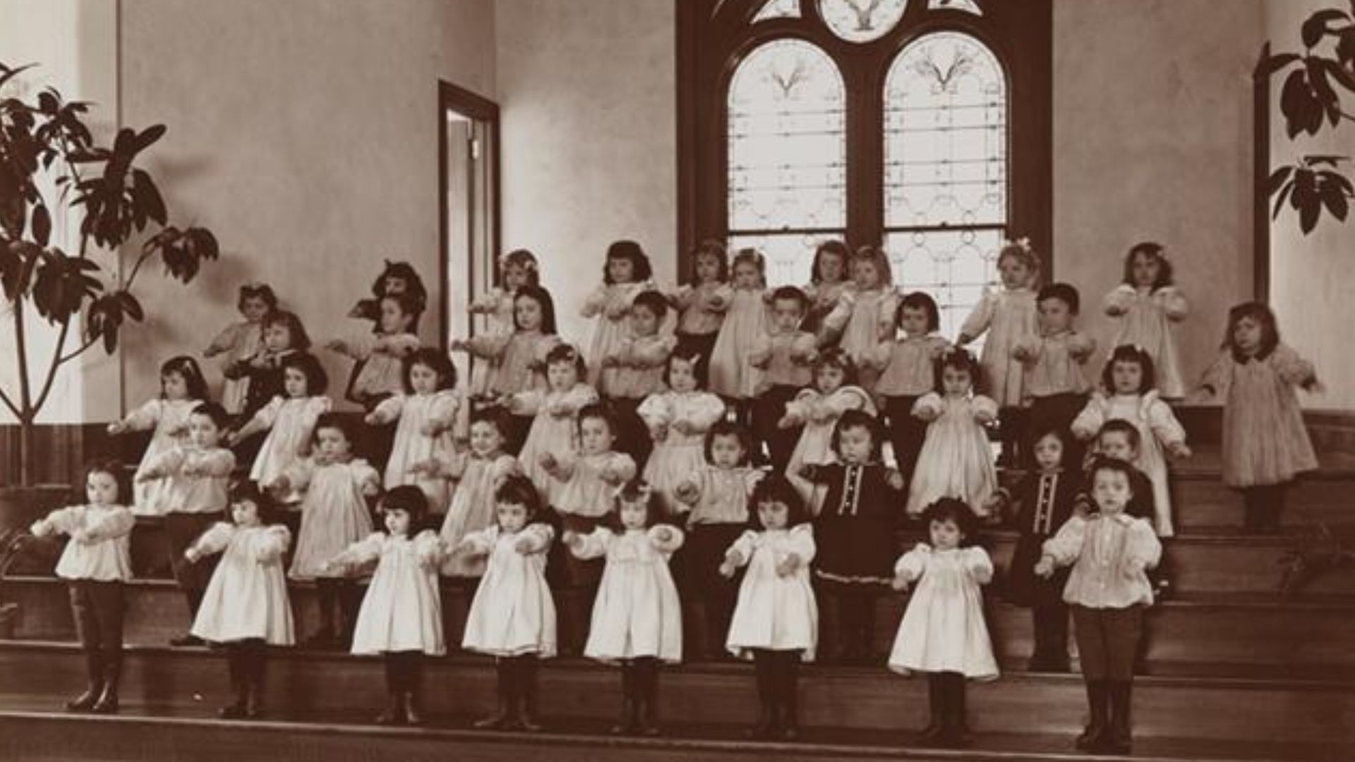 Children doing physical exercises in the hall of the New York Foundling Hospital. Photo by Byron Company, circa 1899.