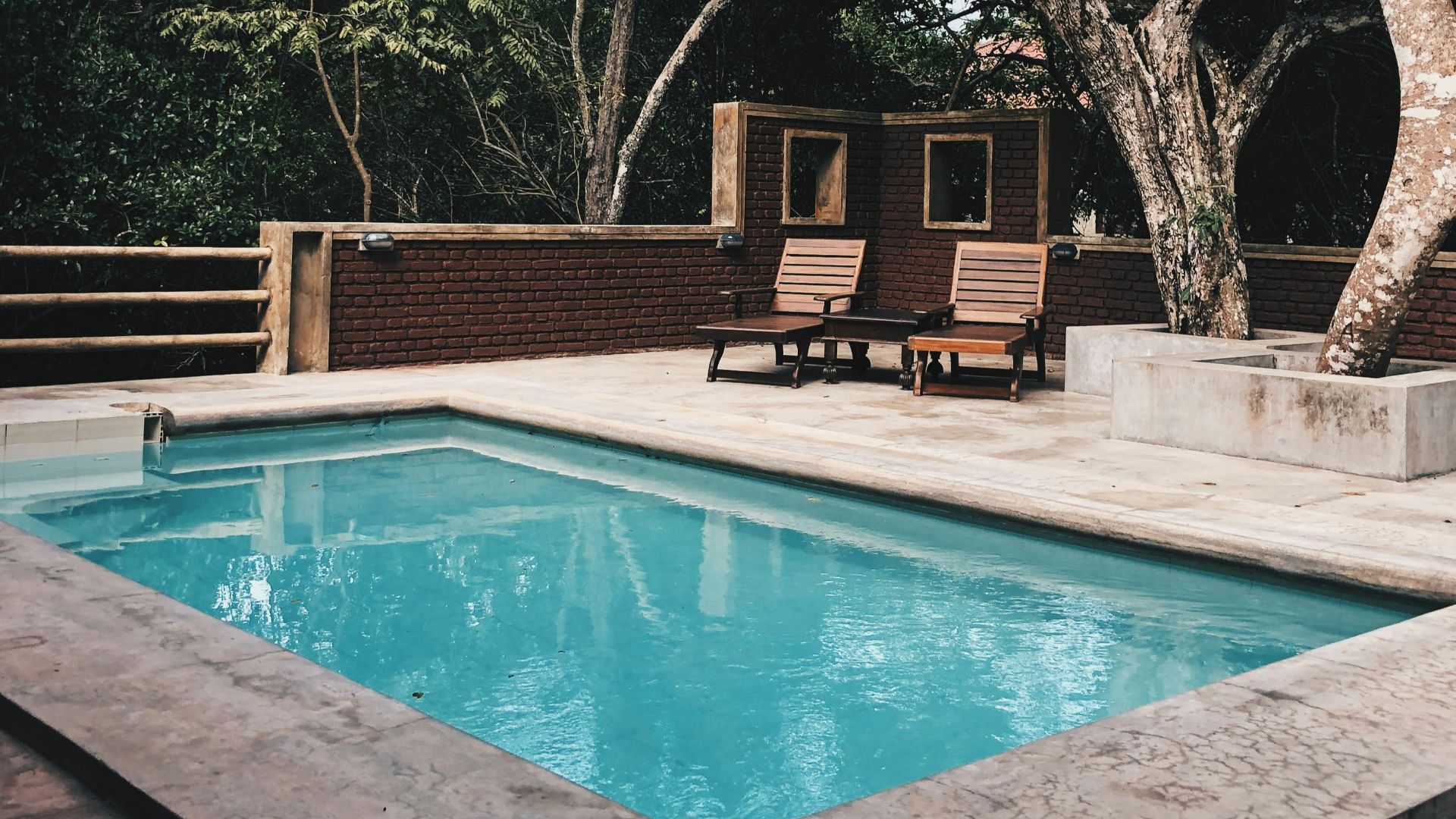 two lounge chairs near swimming pool