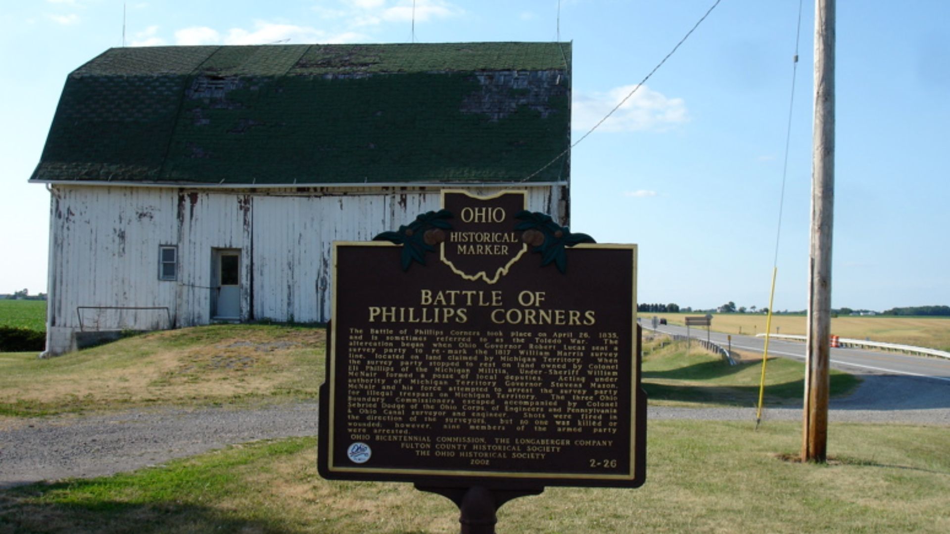 This is a wide shot of the Ohio Historical Marker for the Battle of Phillips Corner, which was part of the Boundary Dispute between Michigan and Ohio. That dispute is often called