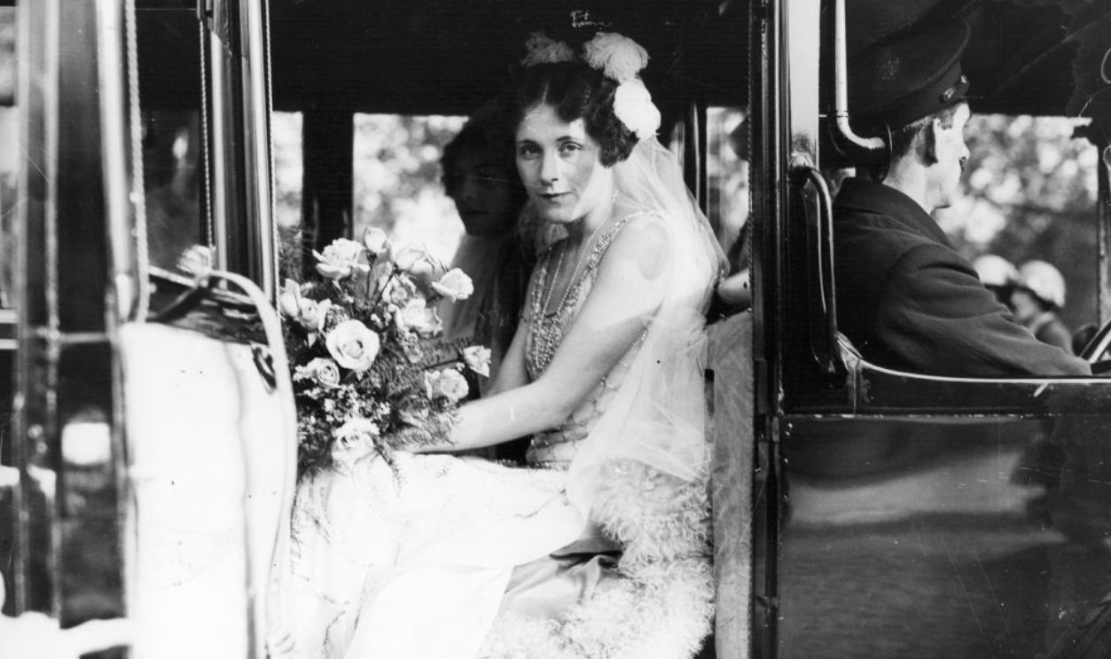 English romantic novelist Barbara Cartland (1901 - 2000) in a car parked on The Mall, near Buckingham Palace, London, before her presentation at court, 1926. Original Publication: People Disc - HC0540 