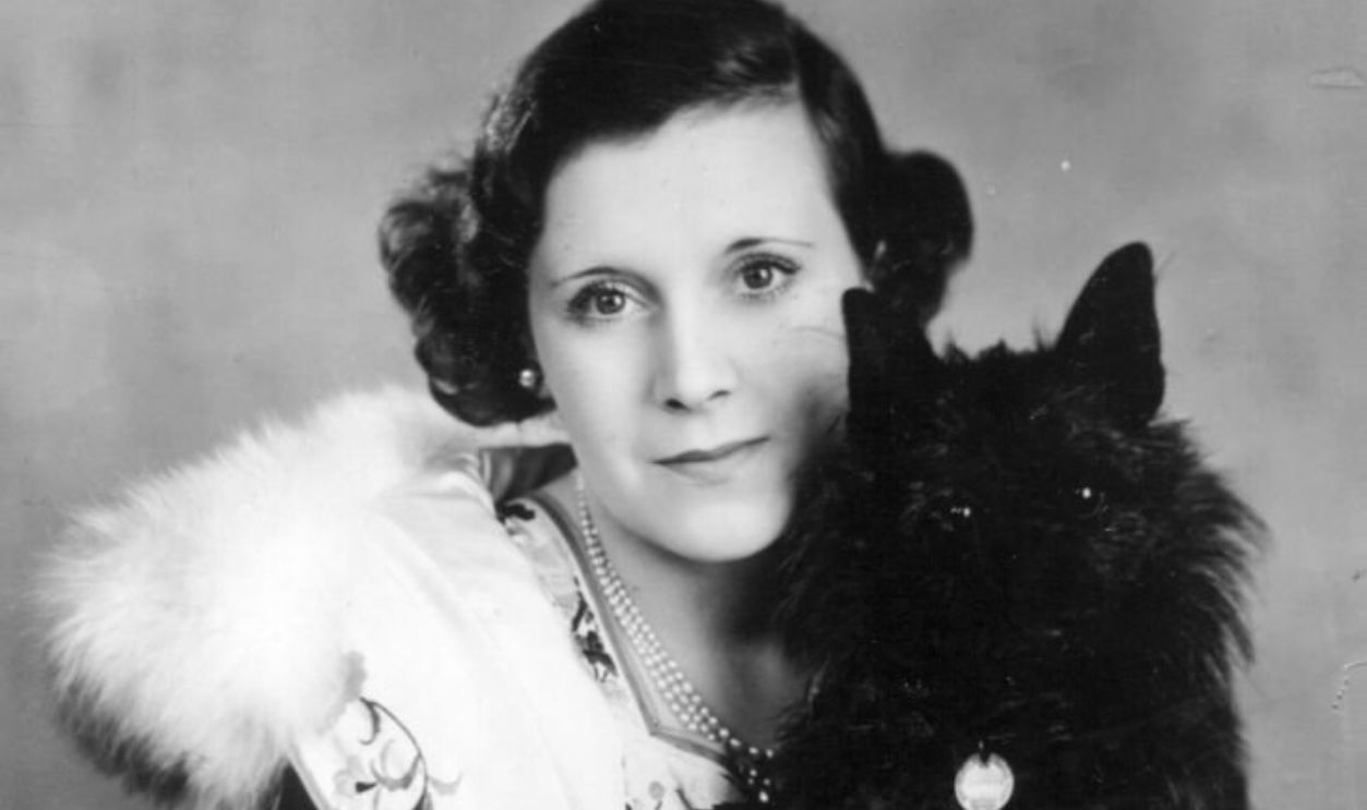 1st May 1930: English romantic novelist (Mary) Barbara Hamilton Cartland (1901 - 2000) holding a pet dog. 