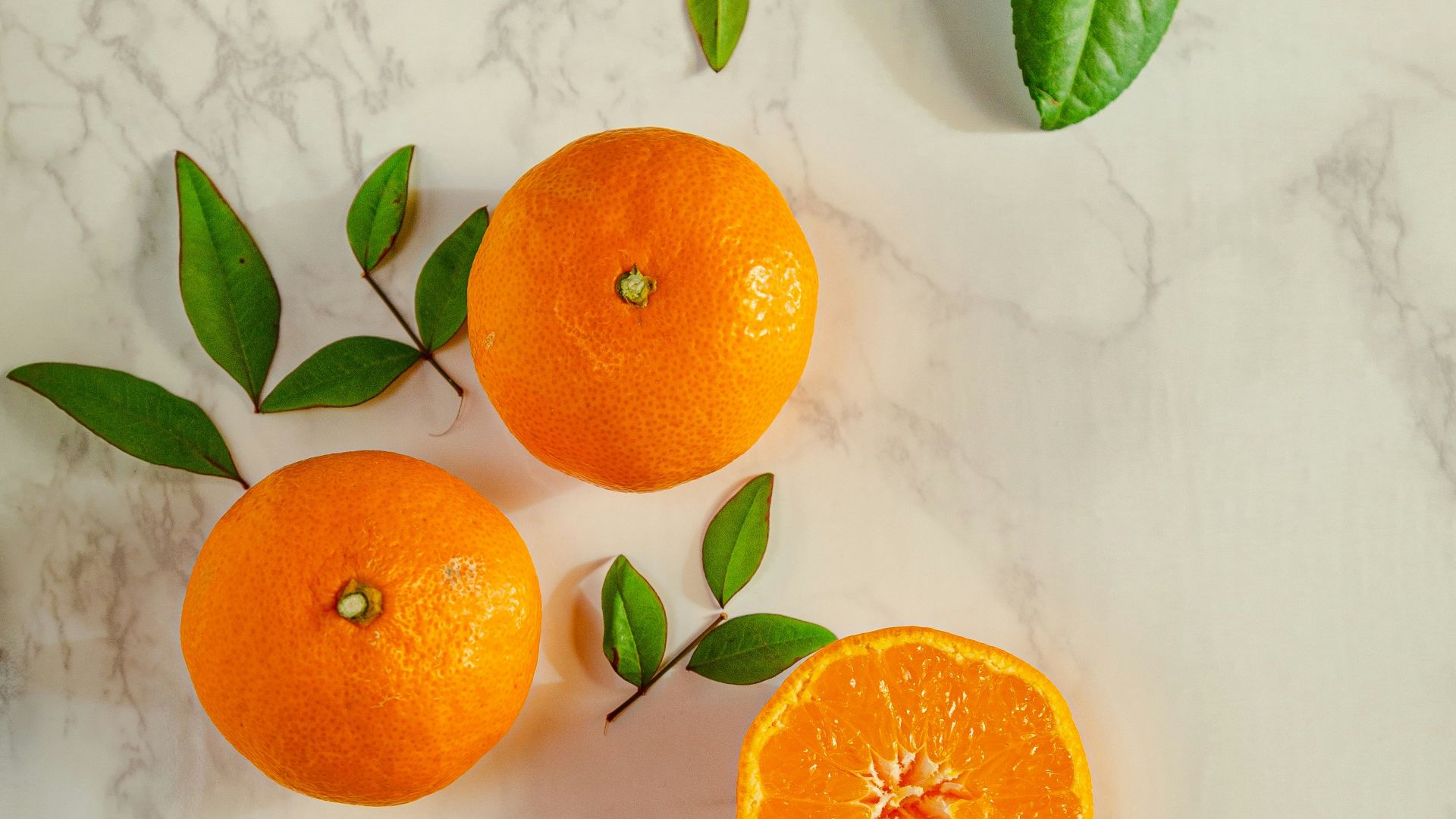 sliced orange fruits on white surface