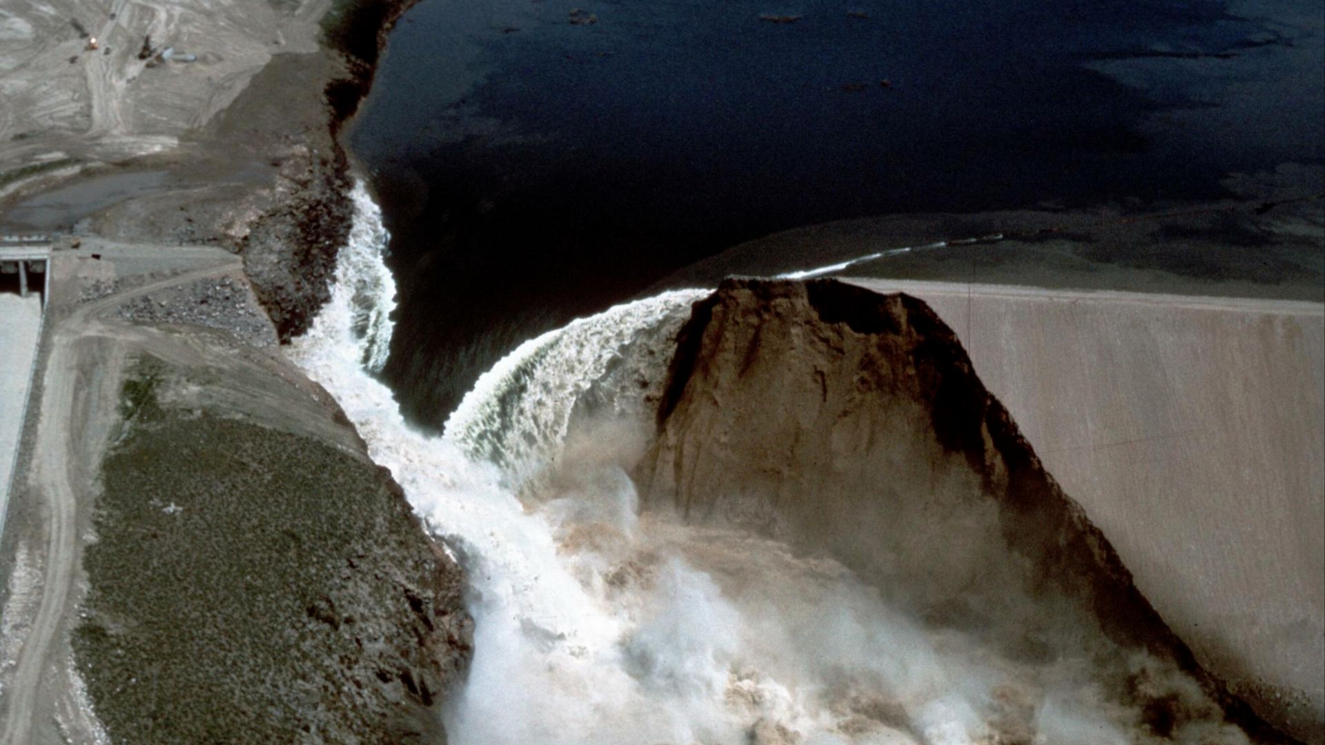 Image Title: Teton Dam Flood - Newdale
Date: June 5, 1976
Place: Teton River, Newdale, Idaho
Description/Caption: Aerial view of broken Dam.
Medium: color transparency
Photographer/Maker: Roberts
Cite as: ID-L-0010, WaterArchives.org

Restrictions: There 