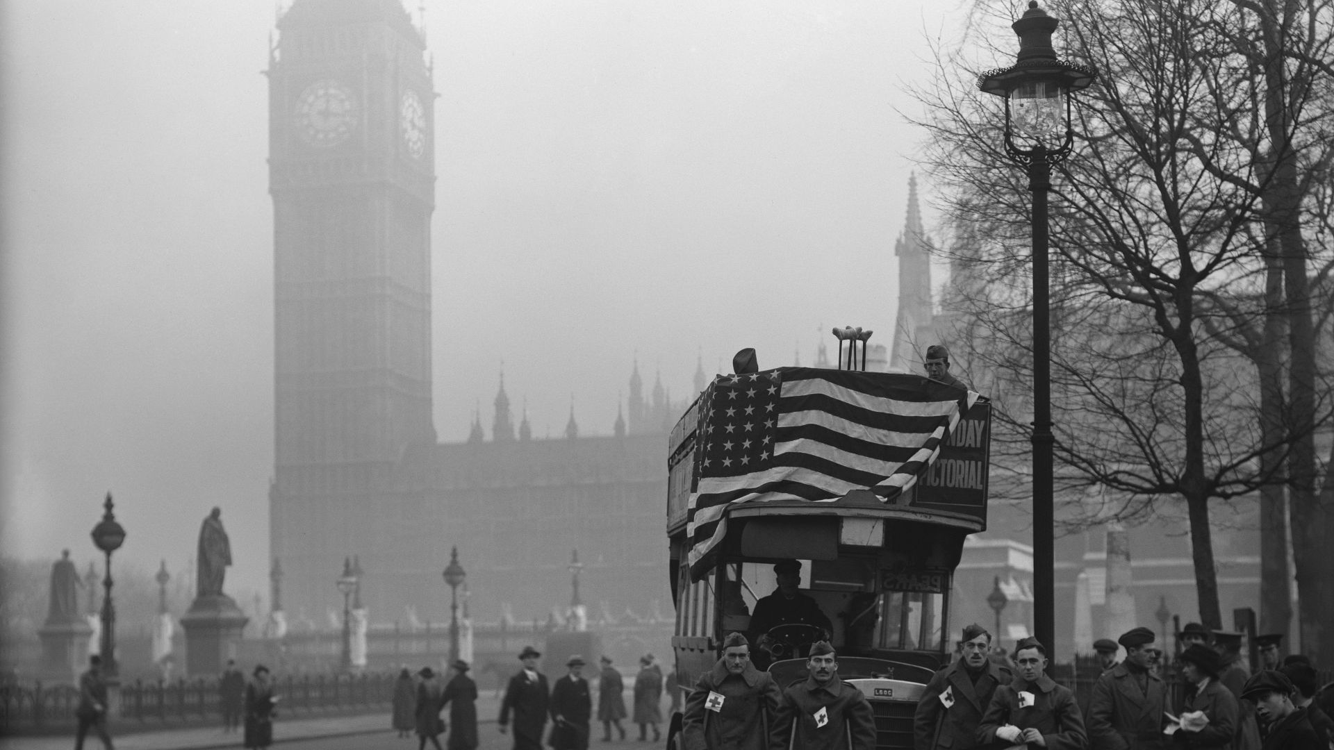 a black and white photo of a bus with an american flag on it