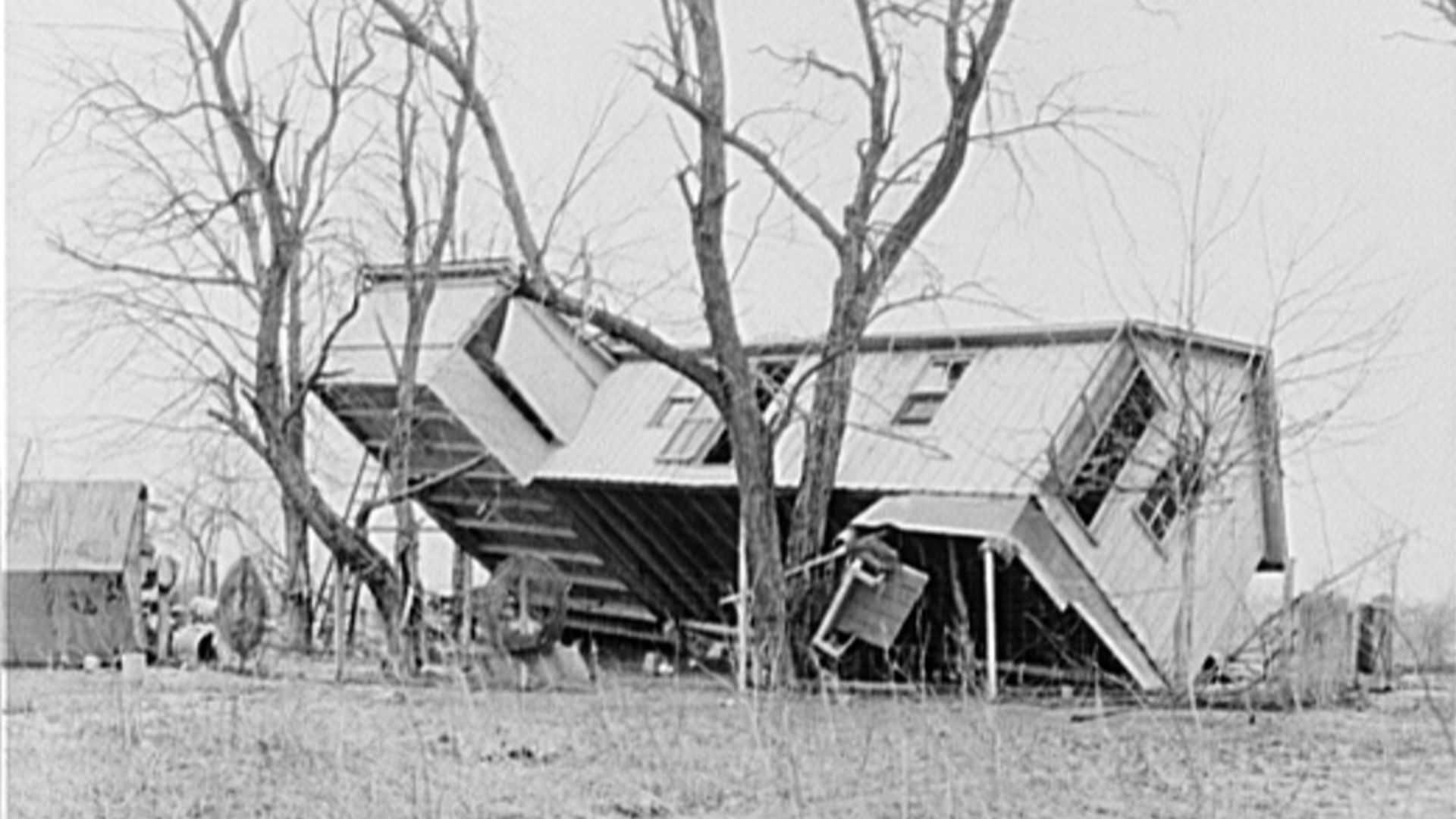 Upturned farmhouse resting against a tree in Posey County, Indiana in the aftermath of the 1937 Ohio River flood.