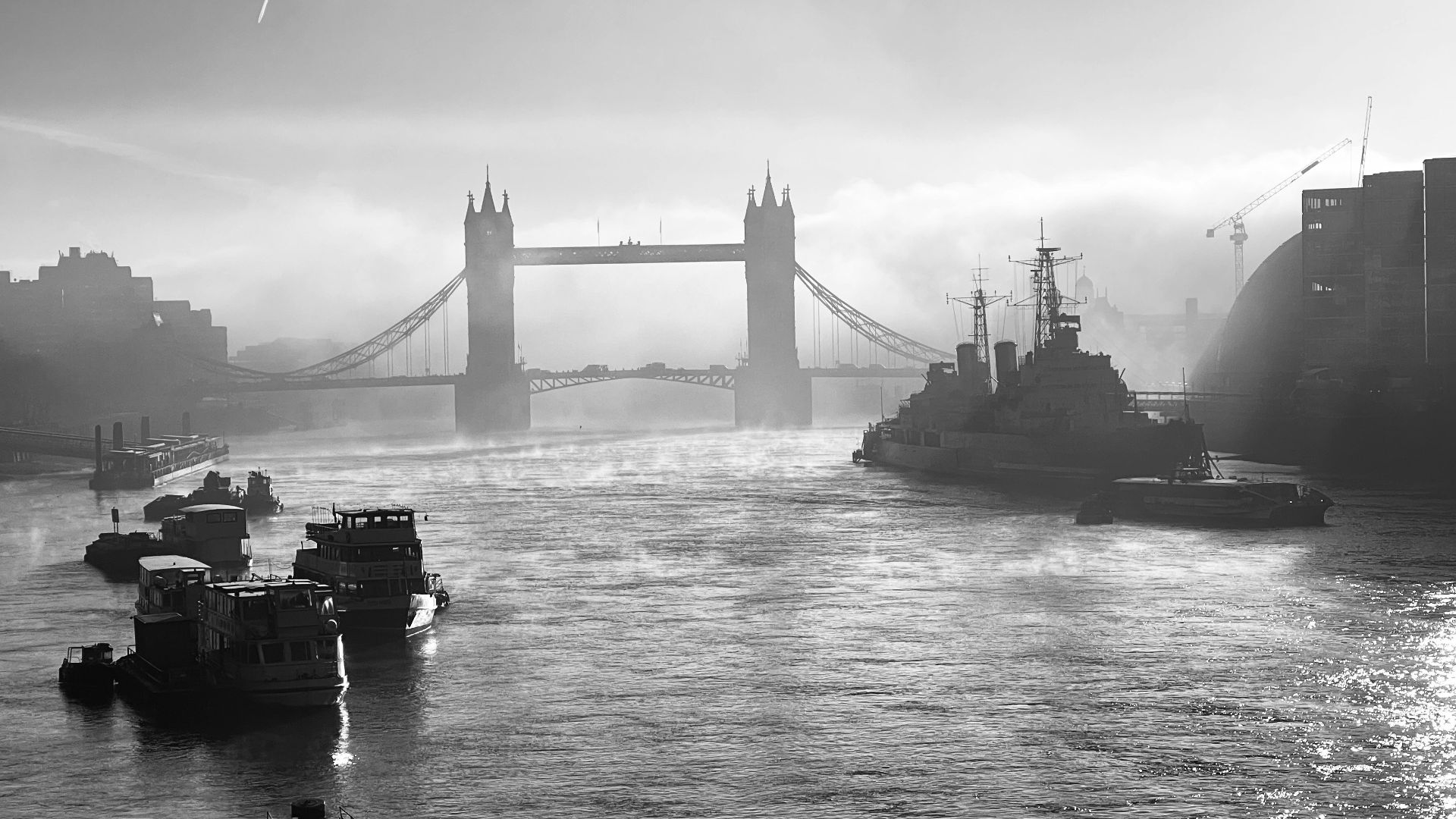 a black and white photo of boats in the water