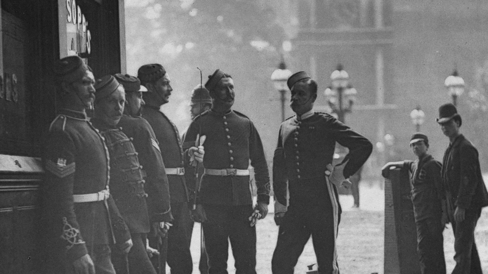 a group of men standing next to each other on a sidewalk