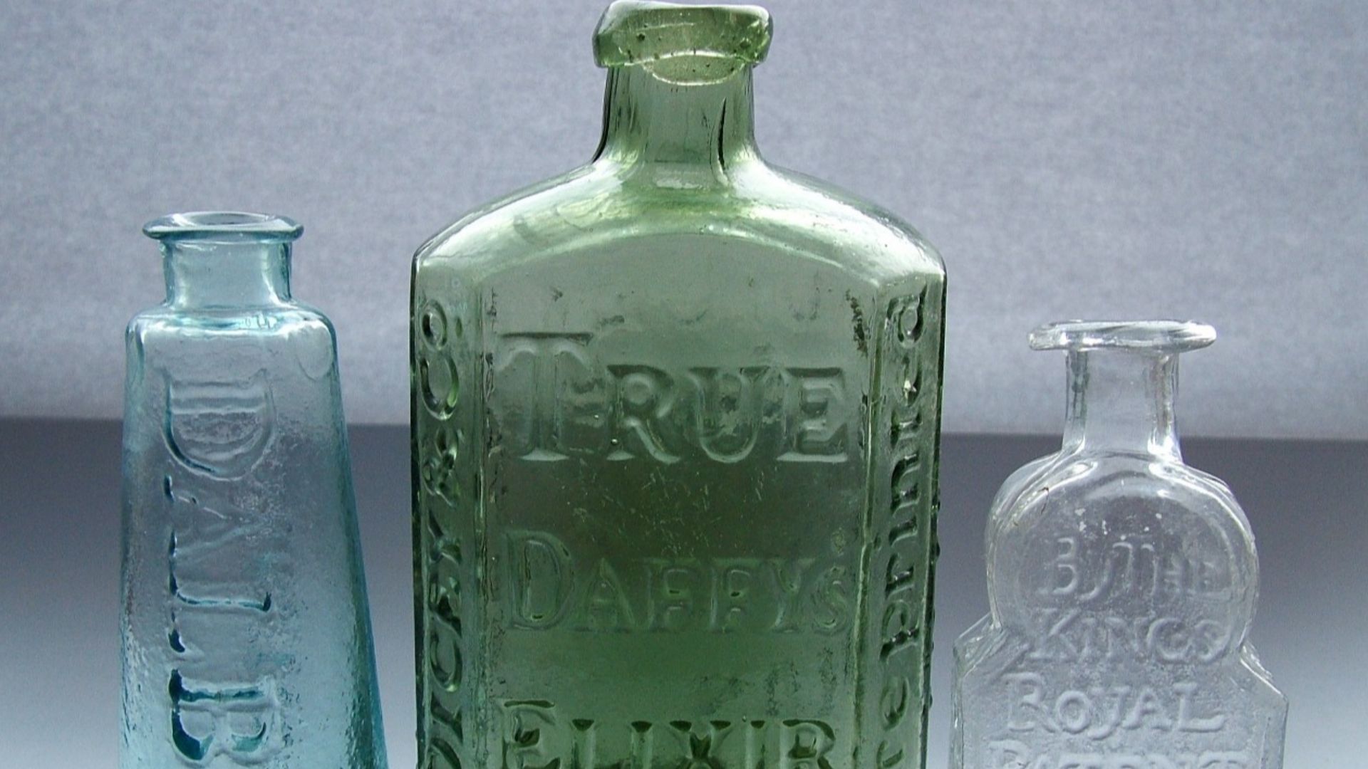 Photograph of three antique patent medicine bottles in my own (username deepestbluesea) collection. These three medicine bottles (Daffy’s Elixir, Dalby’s Carminative and Turlington’s Balsam of Life) nicely illustrate the unusual and distinctive packaging 