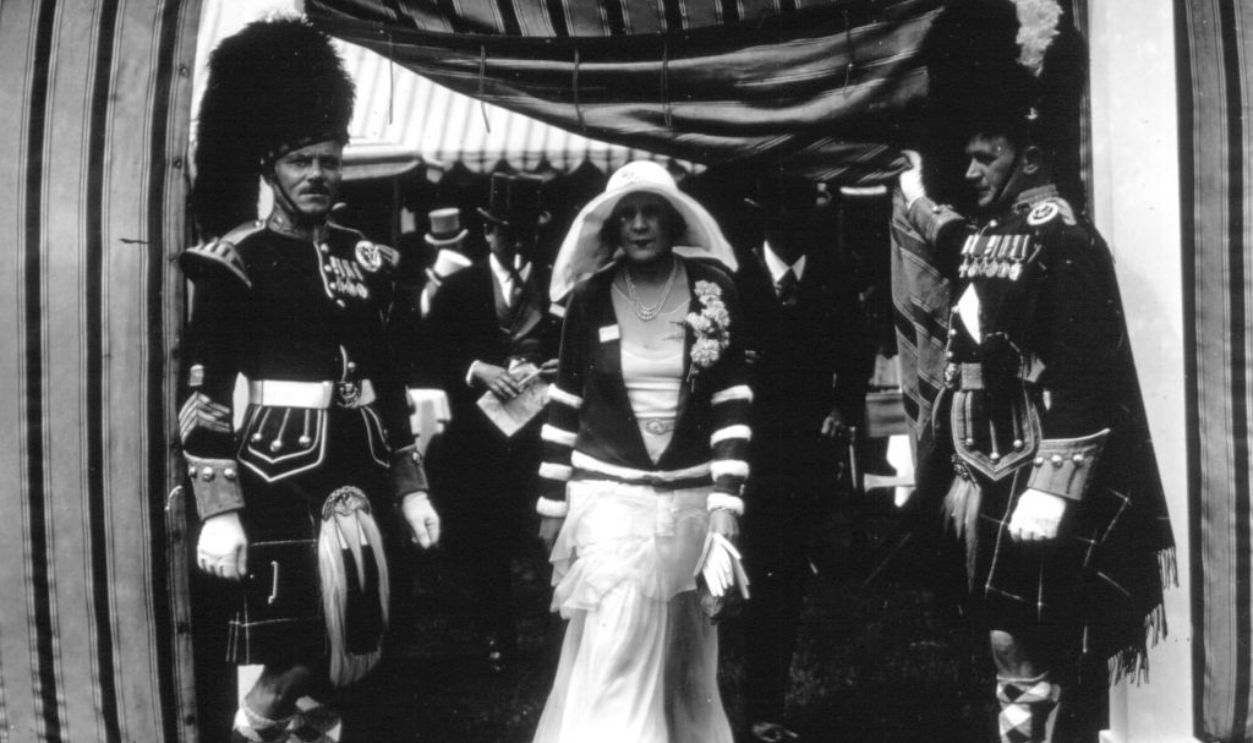 Popular romantic novelist Barbara Cartland (1901 - 2000), while she was Mrs A G McCorquodale, leaving the Highland Brigade Enclosure at Ascot. 