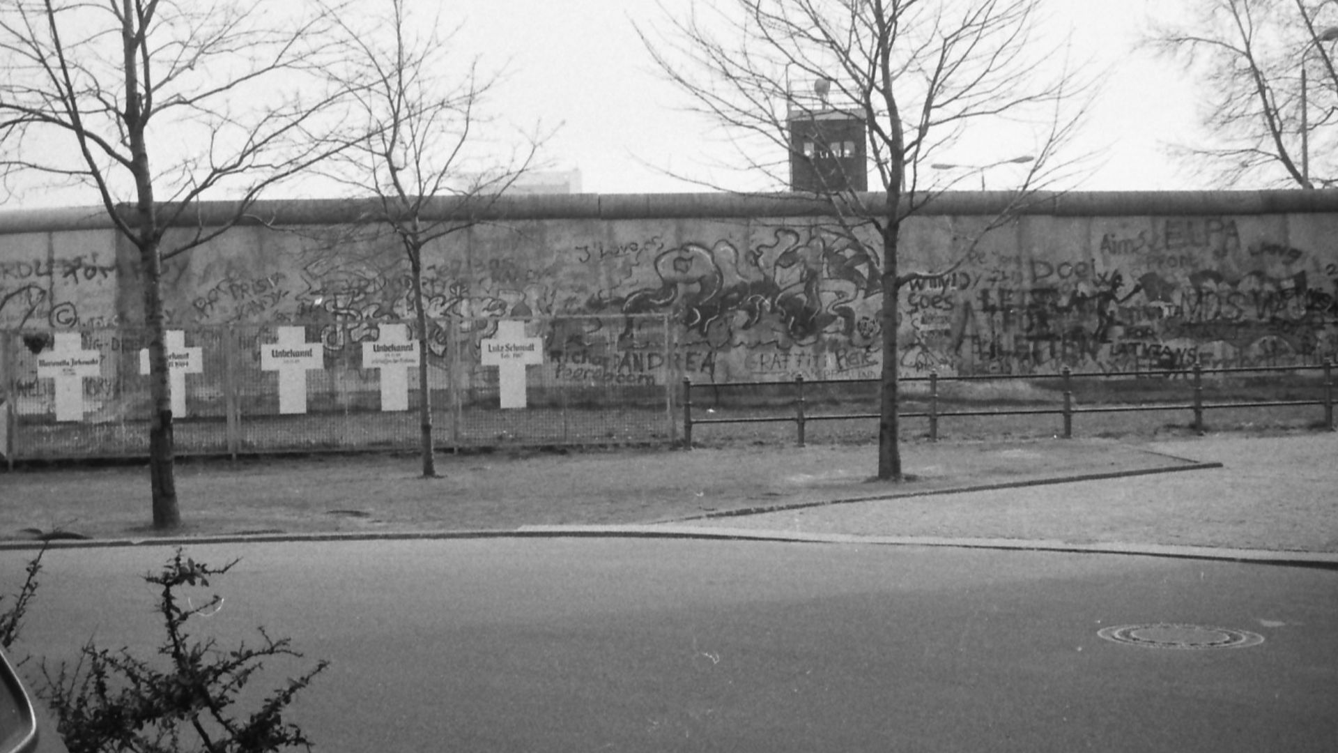 The Wall in Berlin with white crosses on fence