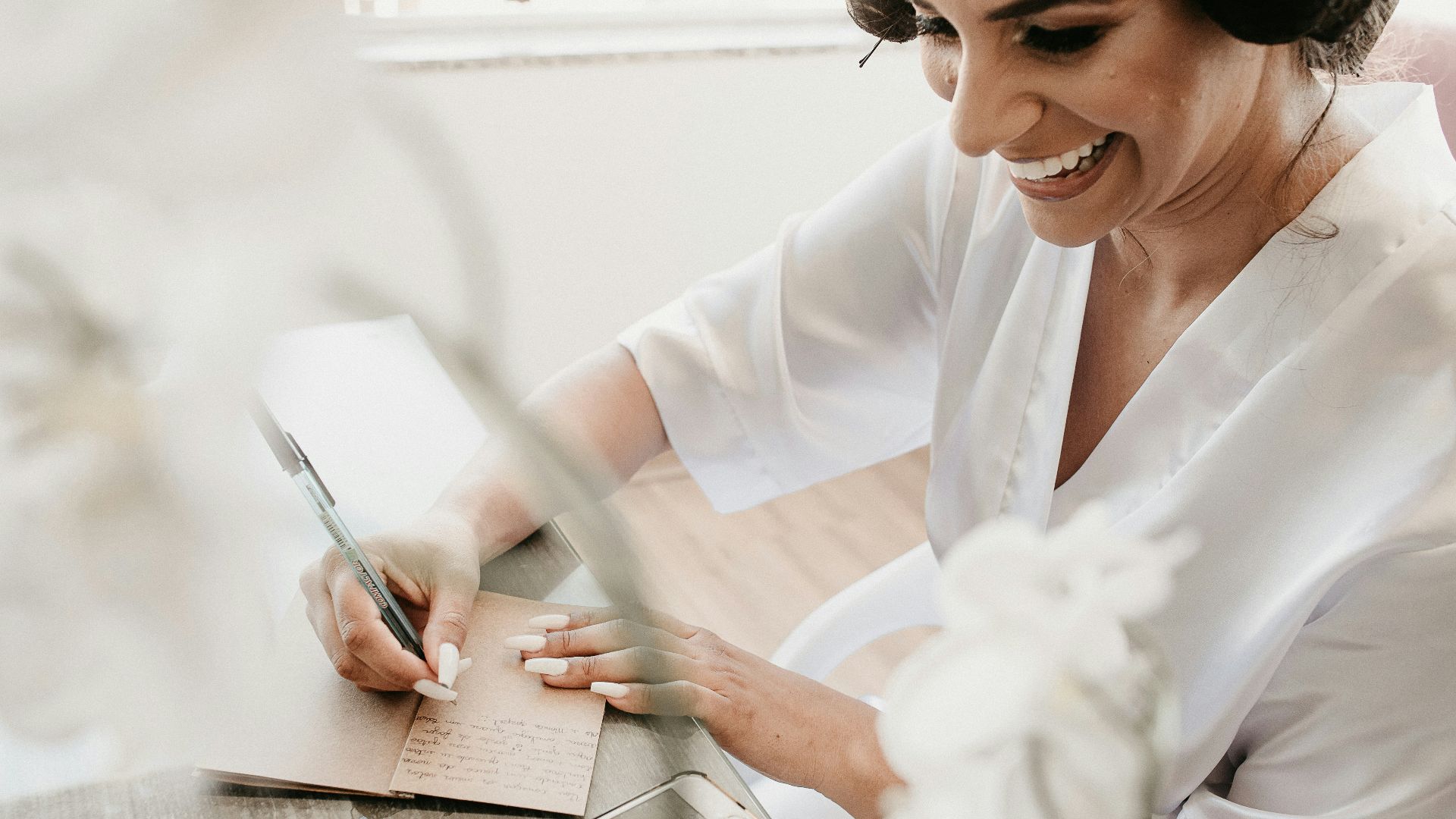 woman in white dress shirt writing on white paper