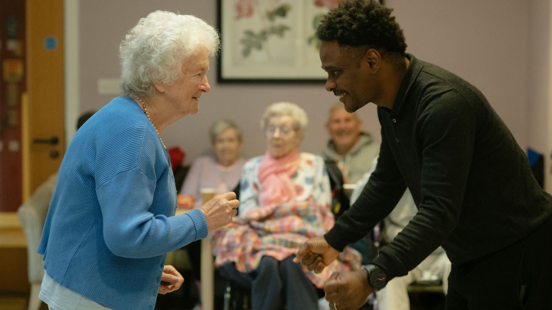 Elderly woman dances with a younger man