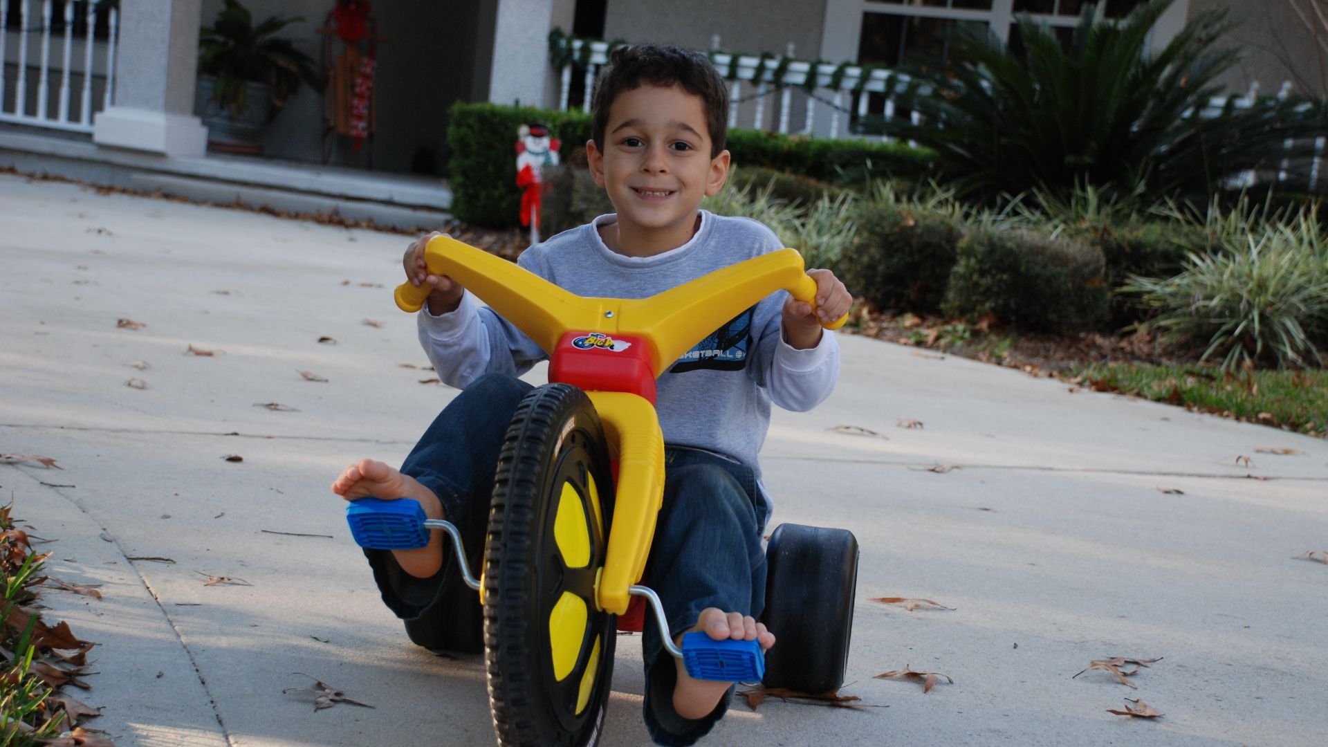 Joe Shlabotnik's nephew riding his Big Wheel in Shlabotnik's parents' driveway.