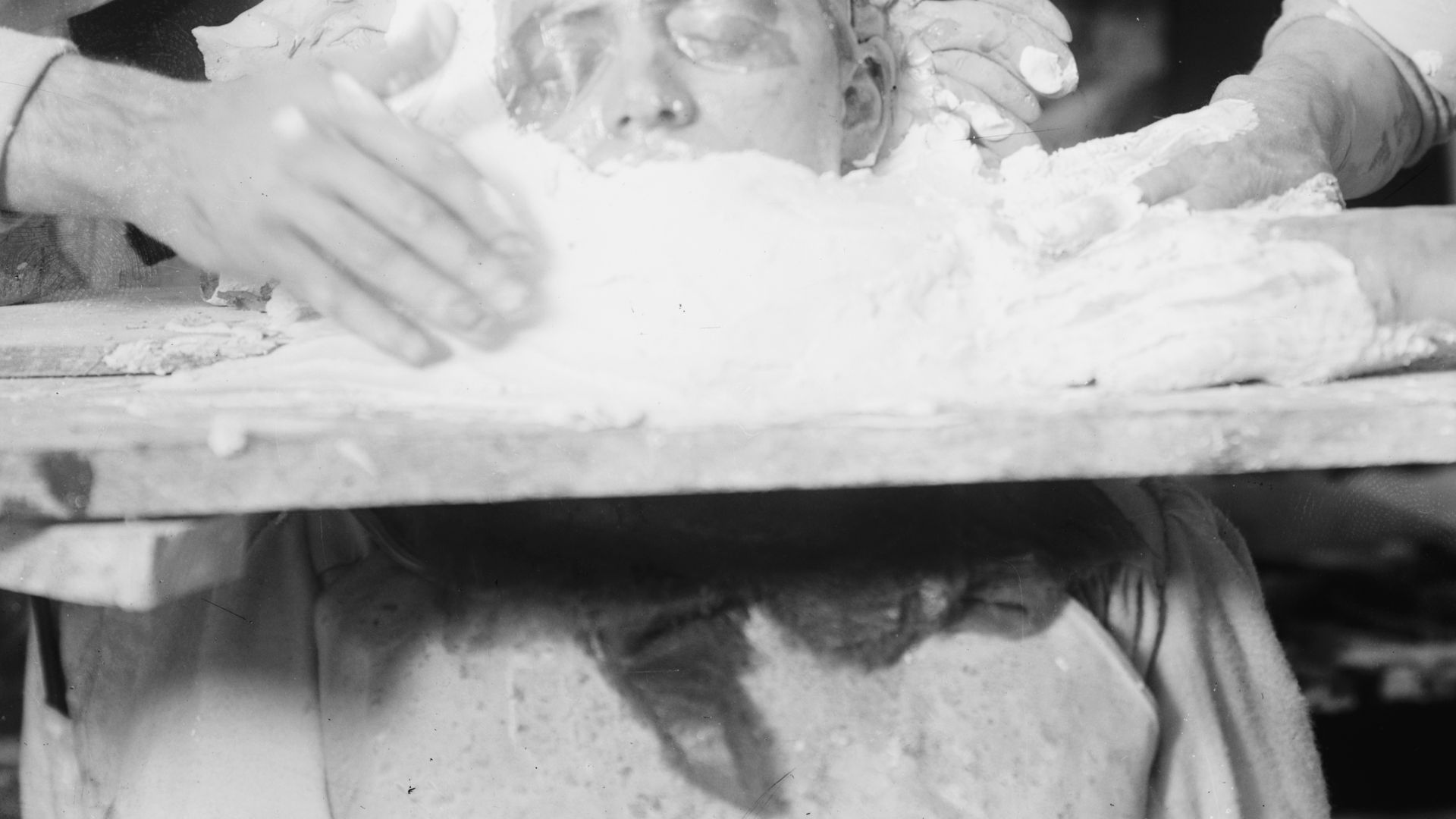 Two men making a death mask