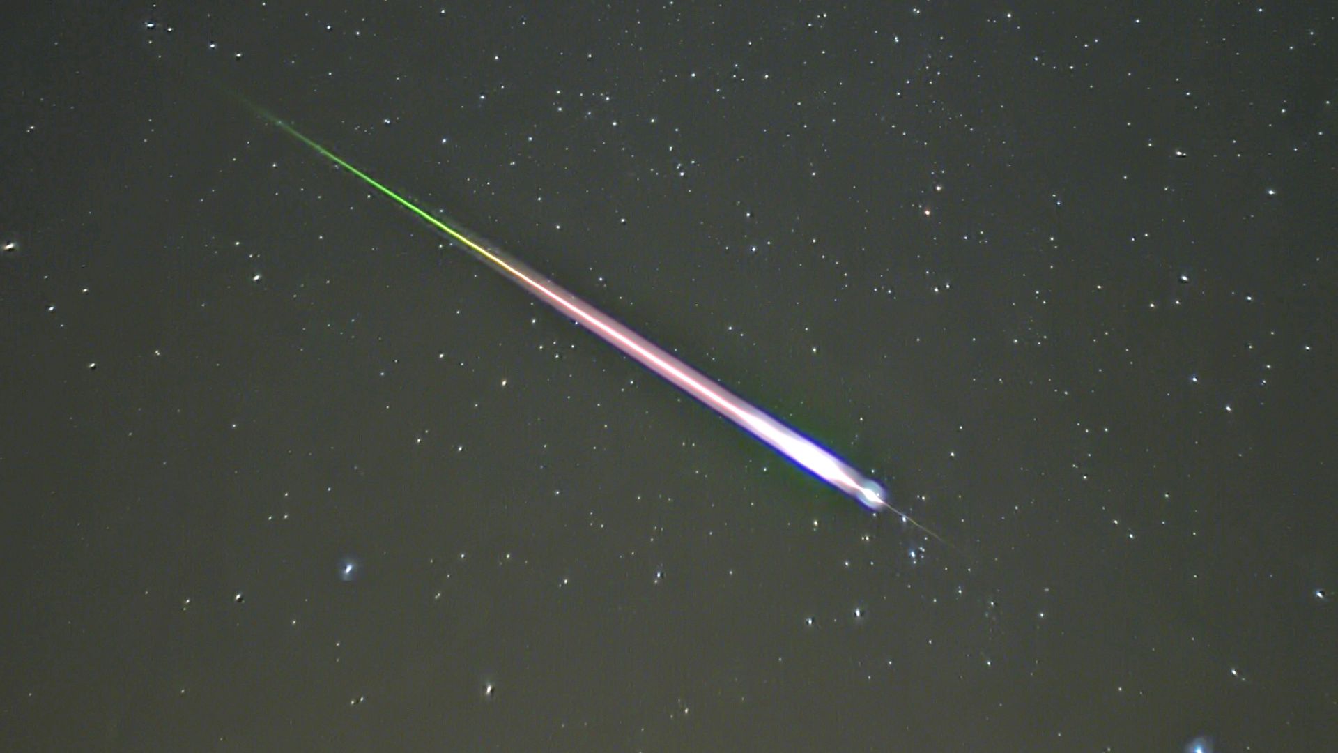 A meteor during the peak of the 2009 Leonid Meteor Shower. The photograph shows the meteor, afterglow, and wake as distinct components.