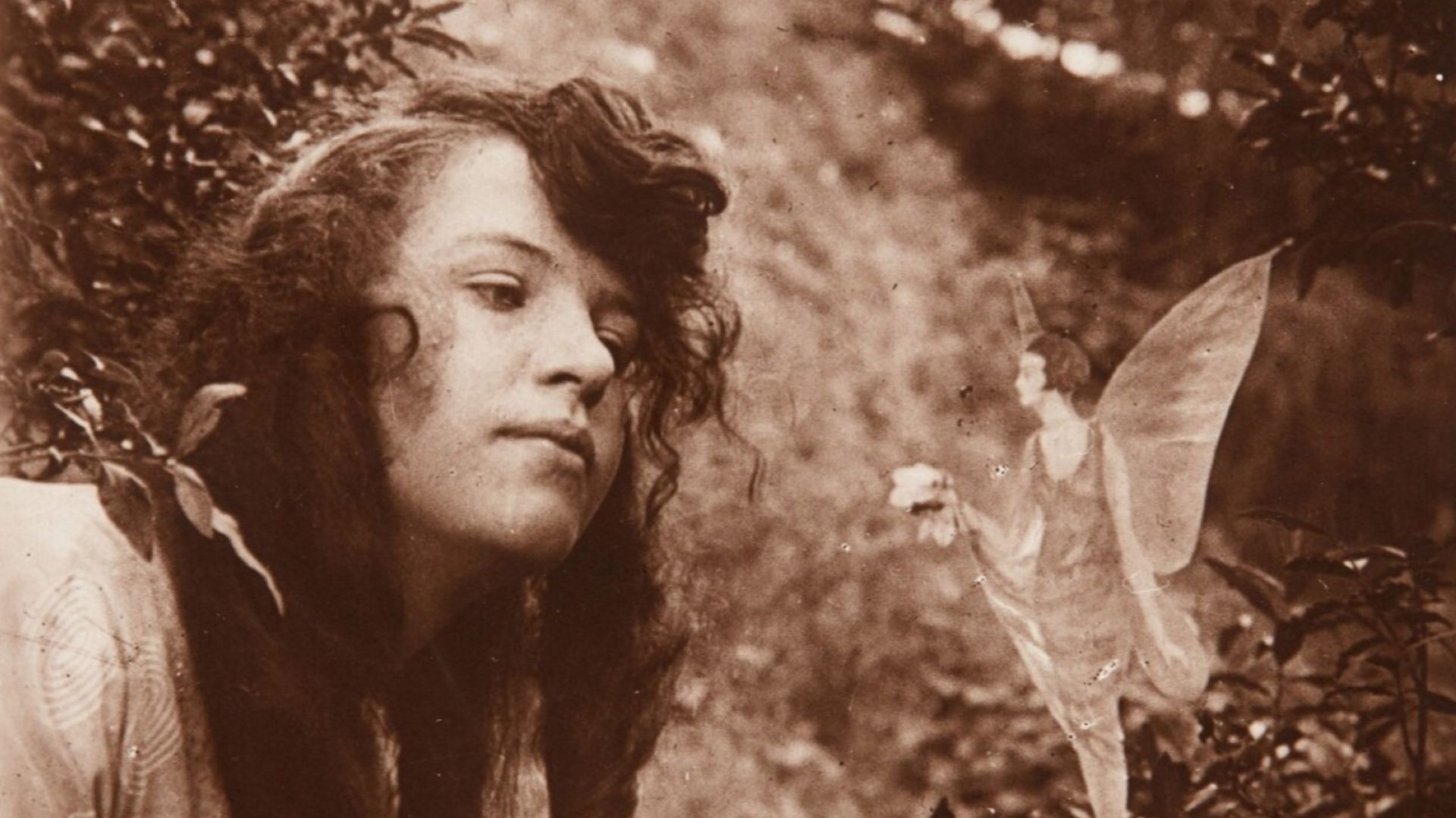 The fourth of the Cottingley Fairies photographs, showing Elsie Wright with a fairy