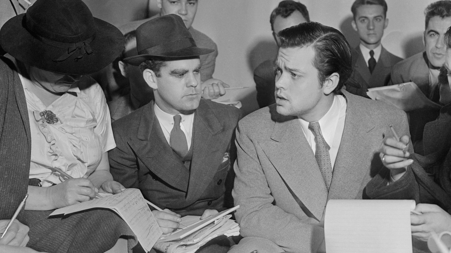 Photo of Orson Welles meeting with reporters in an effort to explain that no one connected with the War of the Worlds radio broadcast had any idea the show would cause panic.