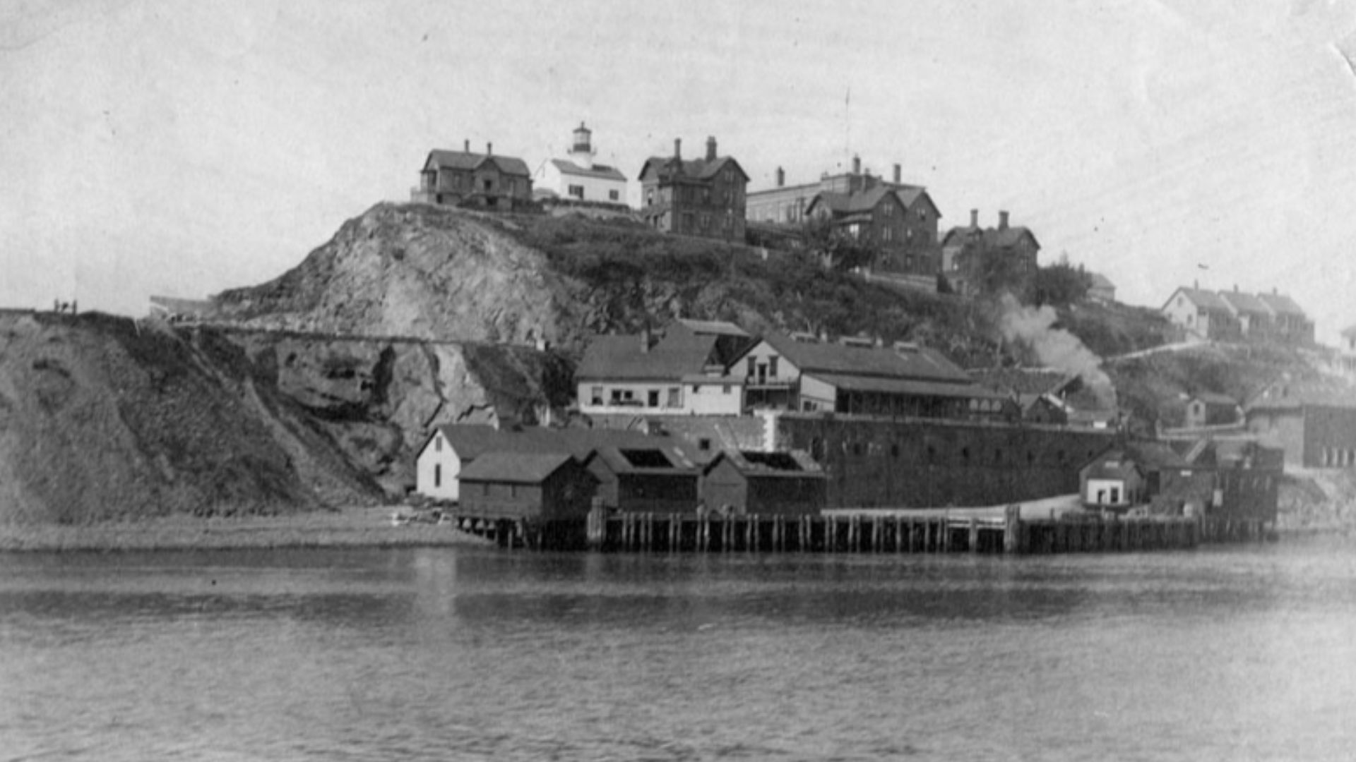 View of Alcatraz Island in 1895, showing the lighthouse and prison buildings.