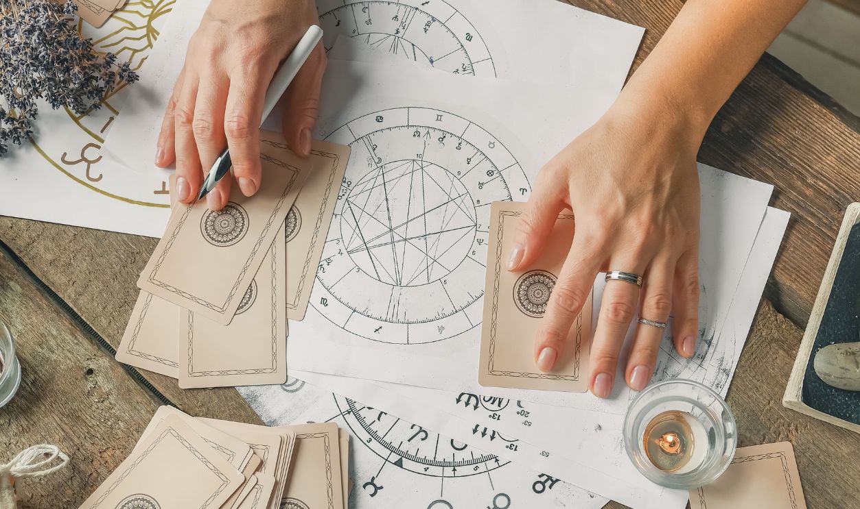 Astrology. Astrologer calculates natal chart and makes a forecast of fate.Tarot cards, Fortune telling on tarot cards magic crystal, occultism, Esoteric background. Fortune telling,tarot predictions.