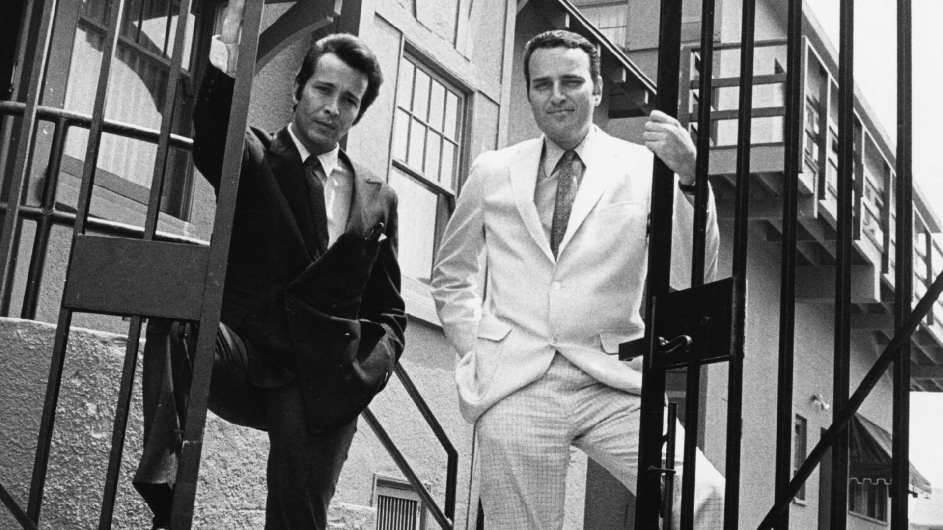 Music producers Herb Alpert and Jerry Moss stand at the gates of their studio in North La Brea Avenue, formerly Chaplin Studios.