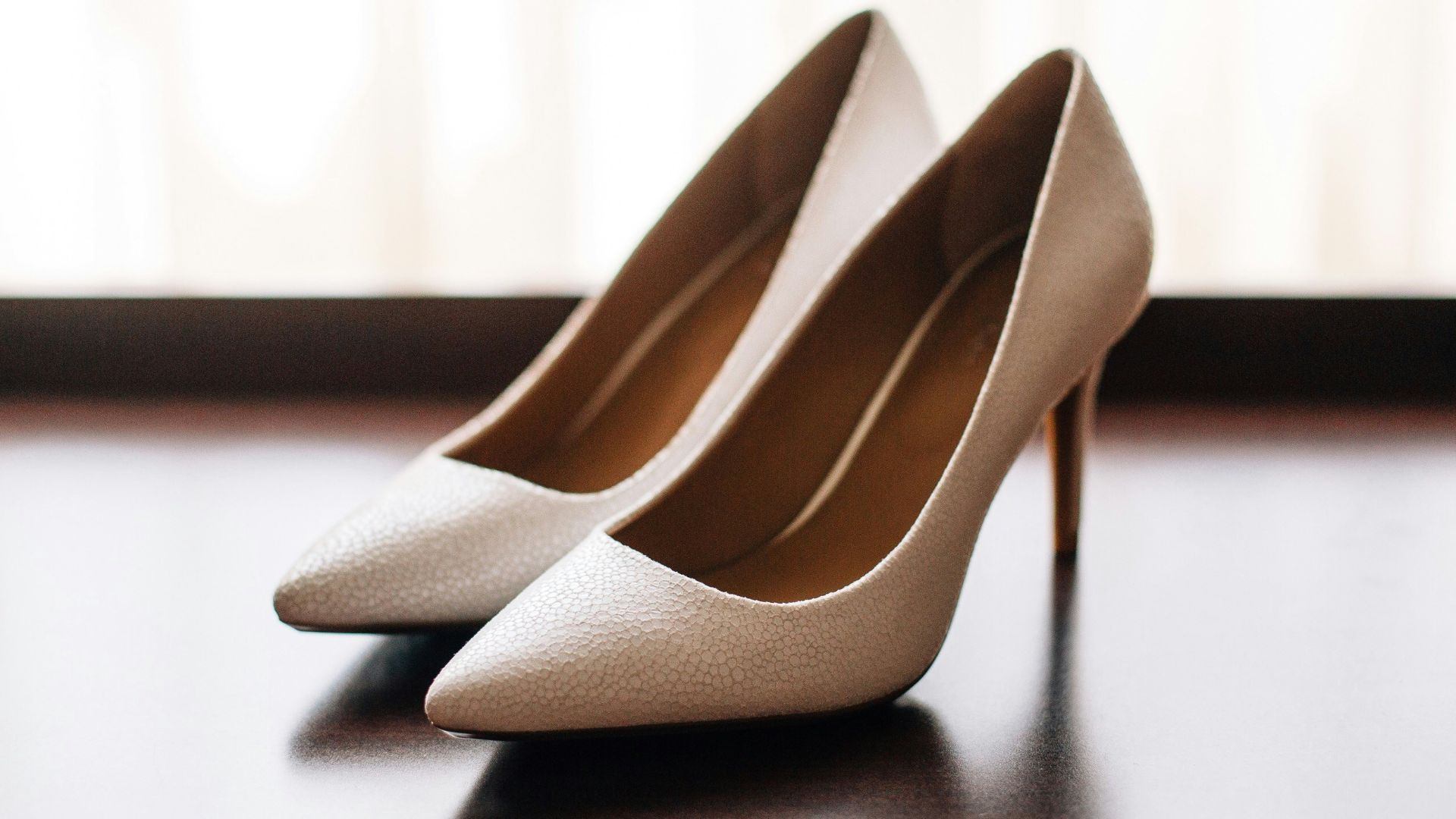 pair of women's brown pointed-toe pumps on board