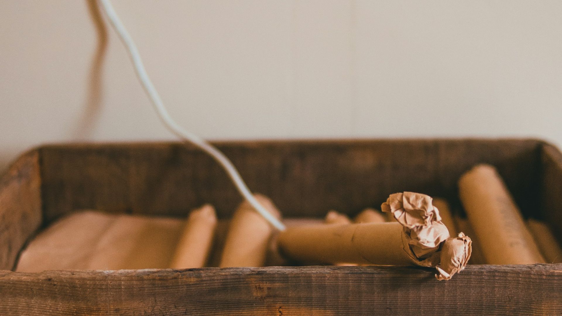 white coated wire on brown wooden crate