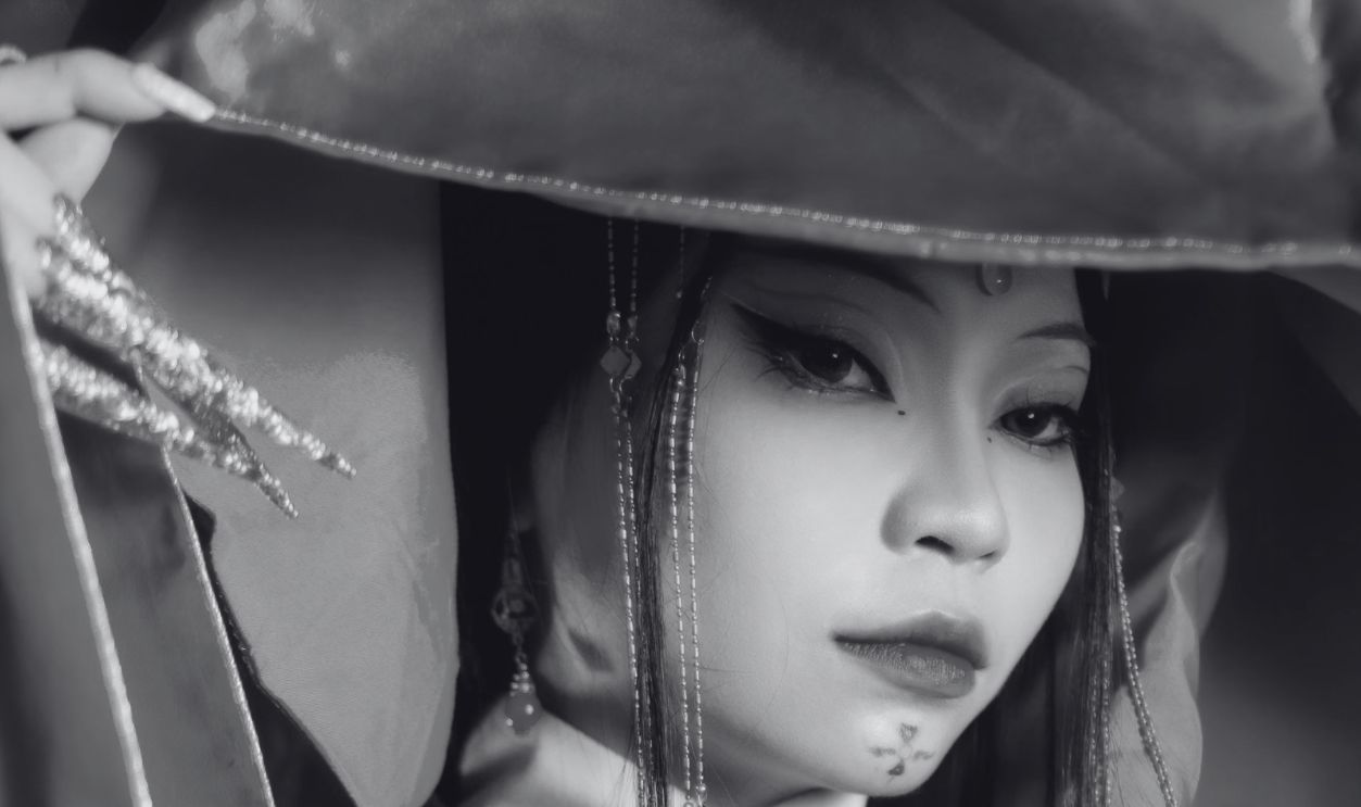 A sophisticated portrait of a woman in vibrant traditional Asian clothing, showcasing intricate designs