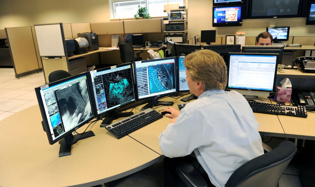 Meteorologist in Work Area in Doppler Radar Station with National Oceanic and Atmospheric Administration NOAA National Weather Service.  Ruskin ,Florida ,Tampa Hillsborough County. Created 08.12.24