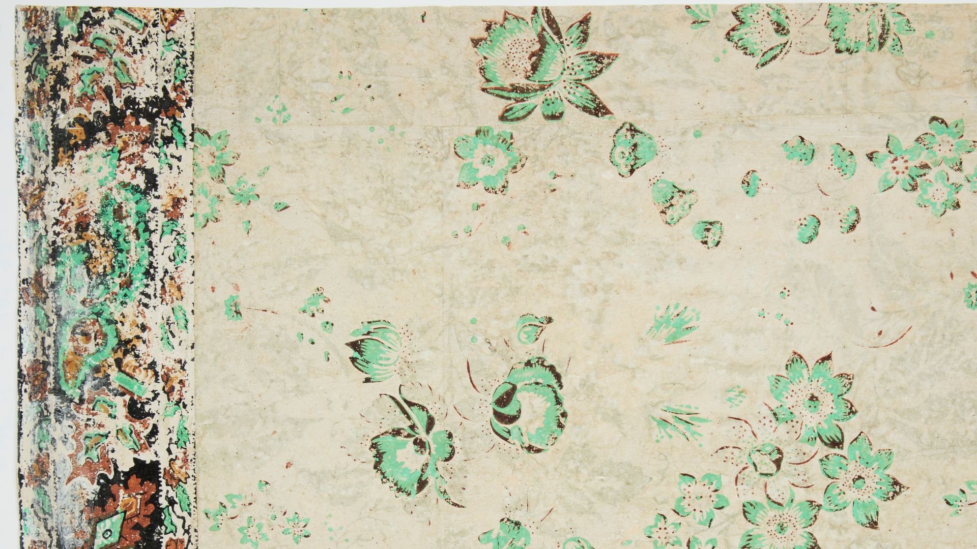 Vining floral design. Most of pattern has faded out, leaving bright green flowers. A border runs along the top edge. Green and rust-color flowers, with narrow band along both top and bottom edge of border. Border simulates applique or textile. Green color